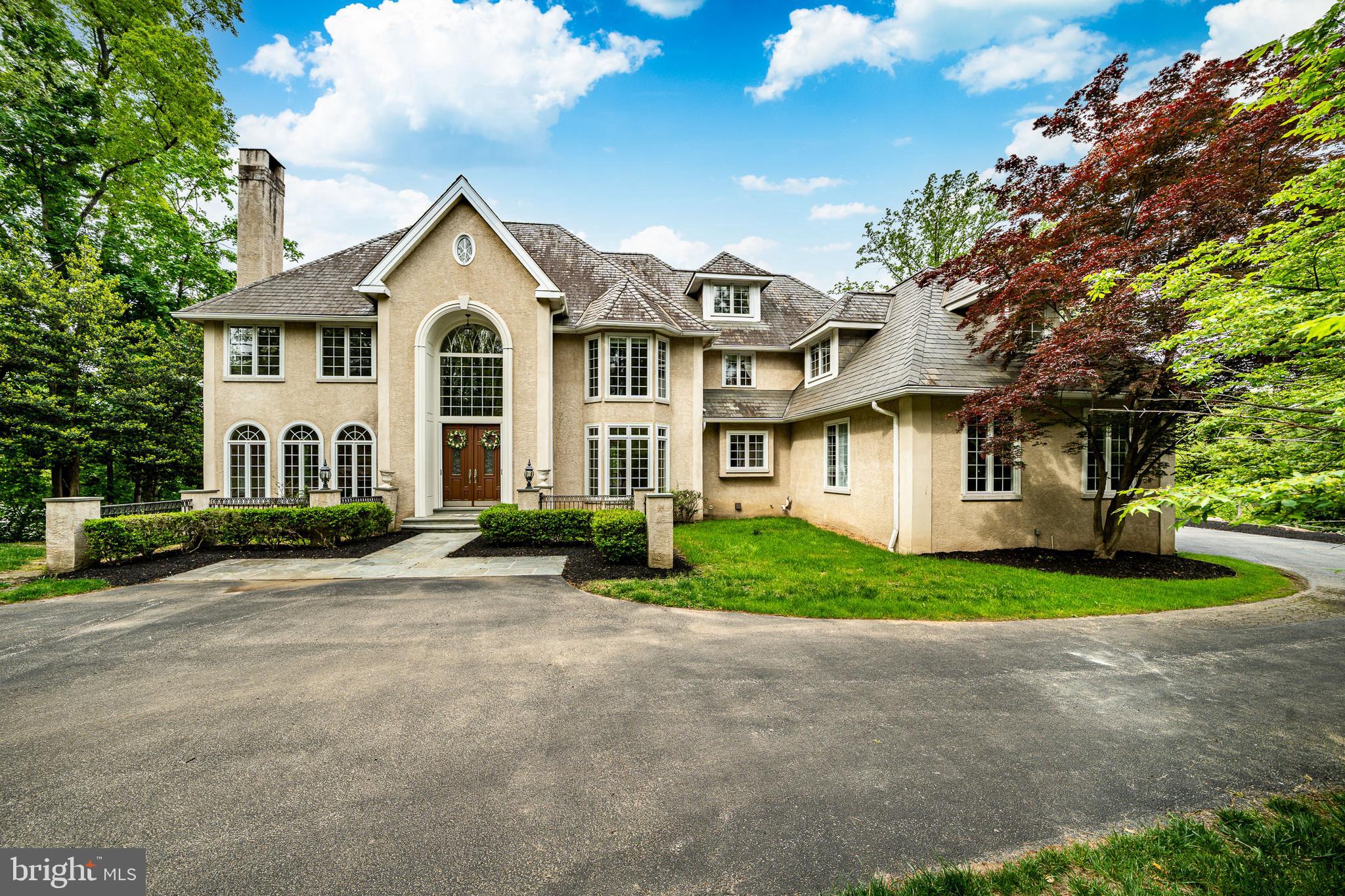 Welcome to 606 Longchamps, a truly spectacular 6-bedroom, 5 full and 2 half bath single family home nestled on a secluded, nearly one-acre wooded lot in the D'Orsey intimate enclave of estate homes community, within the top-rated Tredyffrin-Easttown School District. This remarkable property offers a perfect blend of elegance, comfort, and privacy—truly a showstopper! Approach the home via your long private driveway and enjoy the serene, wooded surroundings. Step inside the grand vaulted ceiling entryway, where the open floorplan flows effortlessly throughout the main level. To the left, the formal living room invites relaxation with its cozy fireplace, intricate crown molding, and abundant natural light streaming through large windows that frame your lush, green yard. To the right, the formal dining room impresses with elegant chair rail and crown molding, accented by a classic chandelier—perfect for hosting dinner parties. The heart of the home is the chef’s kitchen, featuring stainless steel appliances, a large center island with seating and a gas stovetop, and a dining area with panoramic views of the backyard. A built-in desk and cabinet system off the kitchen provides an ideal workspace with scenic views. Additional highlights include a spacious walk-in pantry and direct access to the wrap-around back deck, perfect for entertaining. The family room is a true showstopper, boasting vaulted ceilings, a dramatic floor-to-ceiling stone fireplace, and expansive windows that fill the space with light. The main level also includes a private office with built-in shelving and fireplace, two convenient half baths, and a laundry room for easy everyday living. Upstairs, the luxurious primary suite features plush carpeting, a large seating area, and a spa-like bathroom with dual vanities, built-in cabinets, a soaking tub, and a spacious walk-in shower. The ensuite primary walk-in closet completes this private retreat. Three additional bedrooms—some with private ensuites—offer comfort and style for family and guests. The top floor loft provides a versatile space for a play area or additional living area, complemented by a separate room currently used as a home gym and a full hall bathroom. The fully finished basement adds over 2,200 sq. ft. of living space, including another home office with built-ins, a large recreational area perfect for a pool table, an additional cozy living room with fireplace, and a private downstairs primary suite with ensuite bath and walk-in closet. Outside, your backyard oasis awaits with a wrap-around private deck offering panoramic views of your secluded wooded lot—ideal for summer gatherings and cookouts. Located on a quiet road, you can enjoy private neighborhood living while being close to parks, shopping, dining, and major roadways. 606 Longchamps is more than a home—it’s a lifestyle. This exceptional property seamlessly combines space, luxury, and privacy in one of Devon’s most desirable locations! Schedule your showing today! *** Some photos have been virtually staged.***