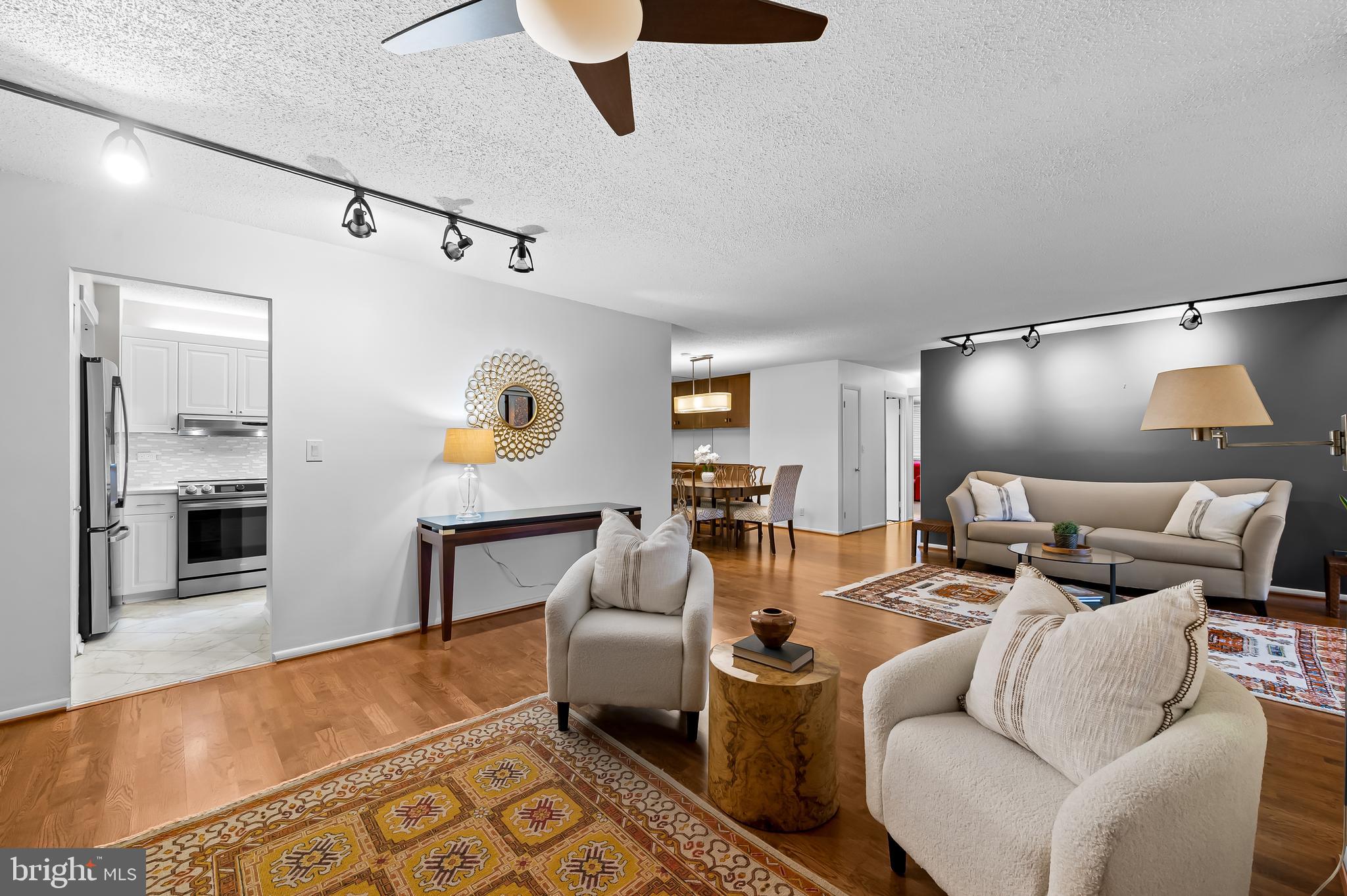 Cross Keys is hot, hot, hot and living at Harper House is easy, easy, easy - it's a winning combination!Welcome to this bright, freshly painted 2-bedroom, 2-bath condominium  offering expansive living space through the living room, dining room and den area, all with hardwood floors. Featuring  a beautifully renovated kitchen with stainless steel appliances, white cabinets and white counters adjacent to a generously sized dining area with custom built-ins.This unit offers two large bedrooms, two tastefully renovated full baths, full-sized washer and dryer, an abundance of natural light and western facing balcony from which to enjoy sunsets. Enjoy the convenience of all-inclusive condo fees in this full service building along with 2 garage parking spaces, additional storage and a 1st floor  guest suite available for rent.  Cross Keys offers 3 community pools, walking paths, security and ever increasing shops and restaurants. and is ideally situated for quick access to downtown Baltimore, I-83 and other local amenities.