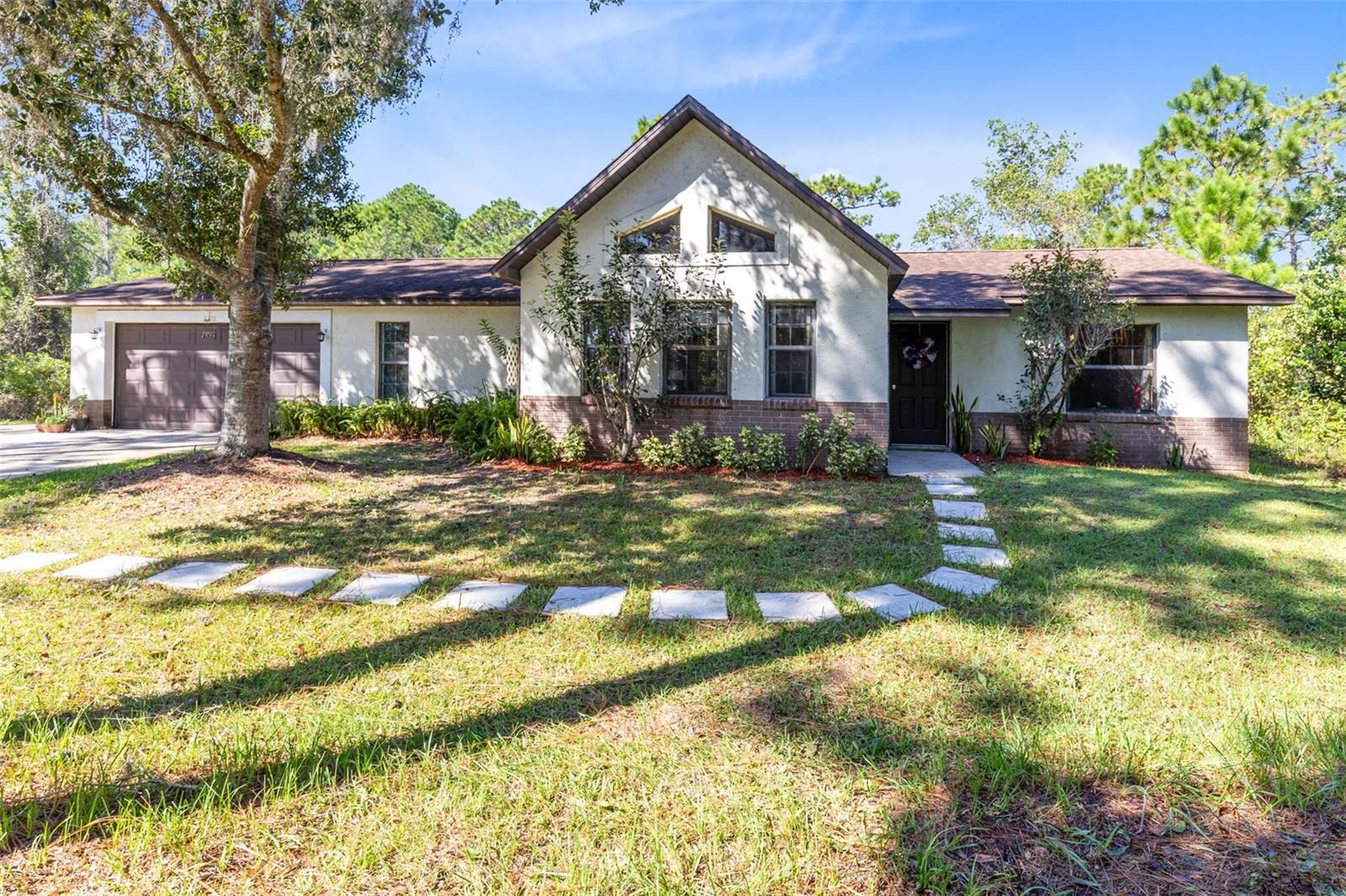 Once in a lifetime opportunity to snag a one-of-a-kind home in the highly sought after non HOA community of Bay Lake Ranch! This custom 3 bedroom 2 bath home is situated on a private, 1 acre lot surrounded by lush, Florida vegetation. Inside, vaulted ceilings and wood beams add charm and whimsy to this home that has been in the same family since they originally designed and built it. Each room is spacious, including the airy the living room with dual fireplace that is open and enjoyable from both the living room and dining room. Beautiful, updated Pergo flooring is found throughout the main living areas and newer appliances adorn the kitchen. Other major updates include a 465' deep artisan well and water softener, new water heater in 2020 and A/C in 2021. This spectacular home is looking for new owners to add their personal style updates to transform it into their dream home!