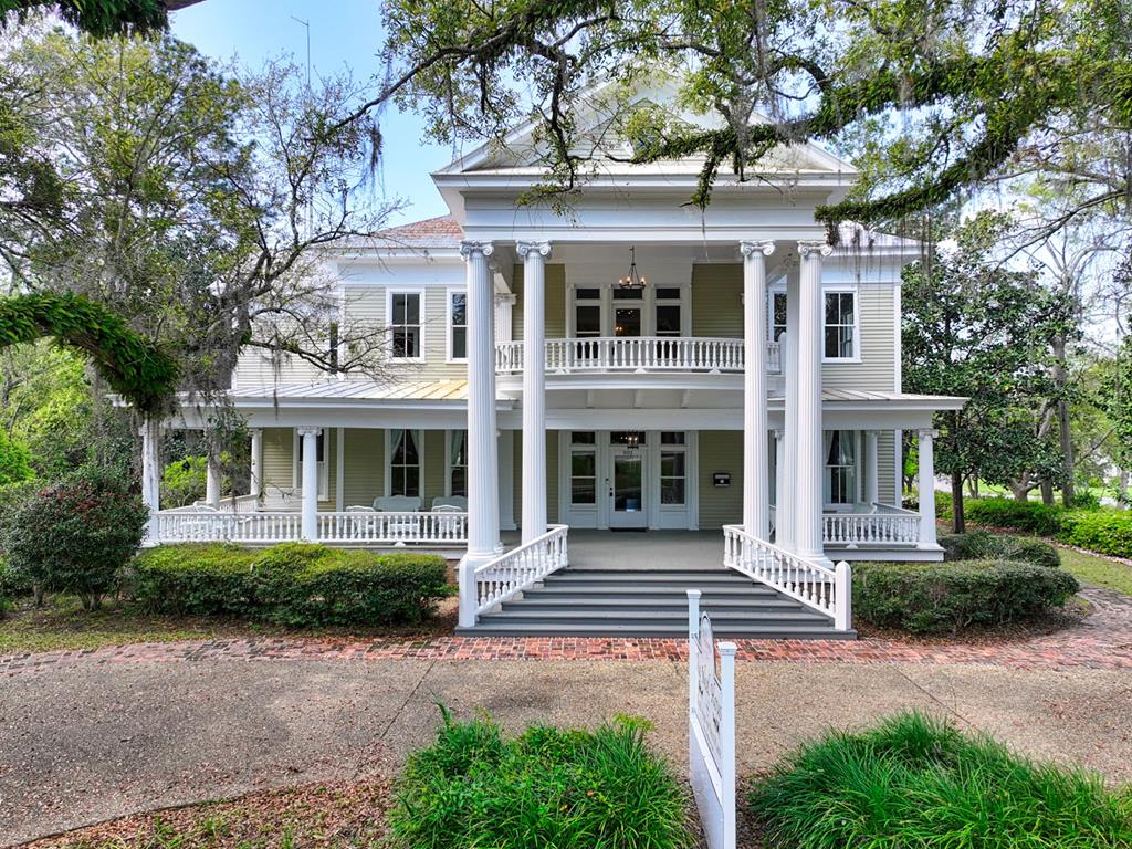 Own a Piece of Downtown Thomasville History! Spanning three stories and nearly 8500 square feet, The Neel House sits on a one-acre lot across from Paradise Park. This historic landmark built in 1907 showcases stunning neo-classical architecture, including a distinctive round gable window, fluted Ionic columns, and a grand two-story portico.  Over the years, the Neel House has evolved from a beloved family estate to a restaurant, investment firm headquarters, and even a movie production company. With space for a large commercial kitchen on the main floor and a secondary commercial kitchen on the lower level, it's primed for a variety of possibilities.  Now, it's ready for its next chapter. Whether you envision a restaurant, event venue, innovative office space, or creative hub, its expansive layout and prime location offer limitless potential. Embrace the legacy and let your imagination run wild in this iconic venue. And don't miss the hidden speakeasy downstairs, featuring a stunning hand-milled mahogany bar crafted by Bracey Lumber.