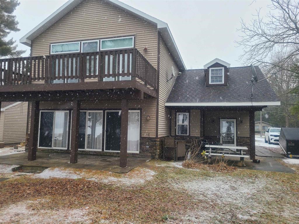 Welcome to lake life in beautiful Up North Michigan! This spacious home offers fantastic views of Cedar Lake with its open-concept kitchen, dining area, and great room - perfect for gathering with family and friends. The kitchen provides plenty of counter and cupboard space plus a pantry to keep everything well-stocked for summer cookouts and afternoon get-togethers. Designed with beach and lake activities in mind, the home features a large mudroom entry for easy transitions from outdoors to in. Upstairs, youll find four nicely sized bedrooms offering plenty of space and privacy, including a primary suite with a private bath. Step outside to enjoy lakefront living on the upper deck or relax on the main-level patios overlooking your own private frontage on Cedar Lake. A private dock makes it easy to head out for boating, fishing, or peaceful sunset cruises. Experience the best of Northern Michigan lake living - comfort, space, and incredible views all in one inviting package.