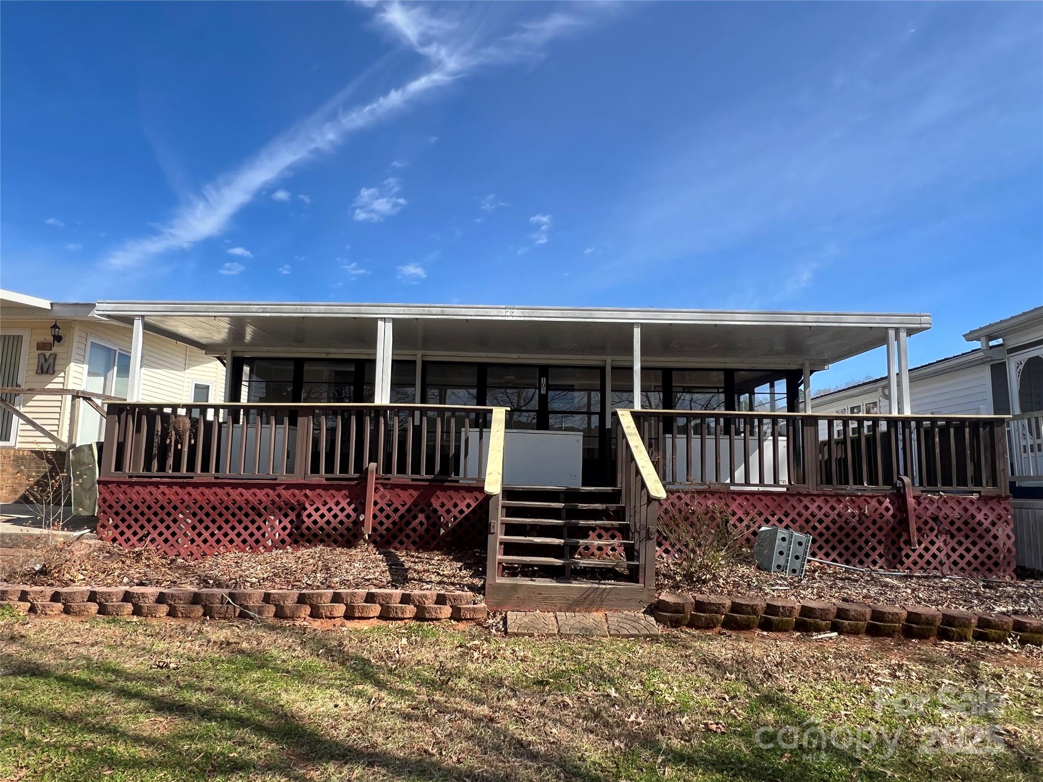 Prime waterfront location inside Badin Shores Resort.  A gated waterfront community with an abundance of amenities. Enjoy lake life with beautiful views year round. This 1985 New Horizon RV home has a sunroom addition offering a wall of windows showcasing the beautiful lake views, sunrises and sunsets. The open kitchen and dining is spacious. The "A" lot allows for additional yard to enjoy along the waterfront. Step onto the boardwalk and walk to the community beach area. Walk to the community Bar & Grill just a few steps away. With an overflow parking lot across the street, guest parking won't be an issue. In addition to the sunroom, a large covered deck will be the ideal spot to hang out. Badin Shores allows golf carts to get around to enjoy all the amenities, including: outdoor pool, putt putt, BB, VB, Horseshoes, RC Track, Laundromat for convenience, fitness room, playgrounds, pavilions, disc golf and more! Don't let this prime spot in Badin Shore get away!  Start Lake Life TODAY!