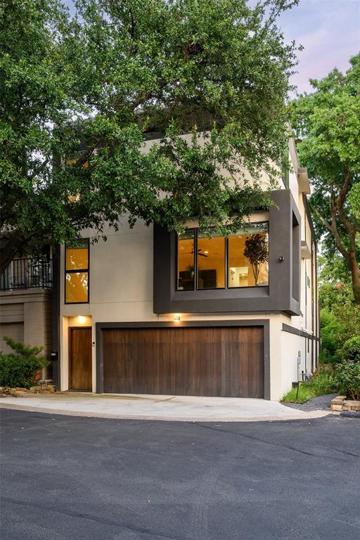 Nestled in the heart of Christopher Place, a private gated storybook community along the picturesque banks of Turtle Creek, this residence blends timeless European charm with modern transitional elegance. Offering four bedrooms, three and a half baths, and an elevator, the home is an architectural masterpiece designed for both comfort and sophistication. The open-concept first floor is bathed in natural light, showcasing museum-finished walls, light hand-scraped hardwoods, and floor-to-ceiling windows that frame serene views of the lush surroundings. At the heart of the home, the European-inspired kitchen is a showpiece, featuring Fisher & Paykel appliances, a gas cooktop, sleek waterfall countertops, custom open shelving, and an expansive walk-in pantry. Designed for effortless entertaining, the living area is anchored by a gas fireplace and extends seamlessly to the dining space. Upstairs, the luxurious primary suite offers a peaceful retreat with a spa-like bath, complete with a soaking tub, glass-enclosed shower, dual vanities, and direct access to a private balcony. An additional upstairs living area opens onto its own spacious balcony, creating a natural flow between indoor and outdoor living. Crowning this exceptional home is a spectacular third-story rooftop deck, enhanced by a glass-paneled railing that maximizes panoramic views of the tree-lined neighborhood. This outdoor sanctuary is perfect for alfresco dining, sunset gatherings, or simply enjoying the beauty of Turtle Creek from above. Christopher Place is a hidden gem in one of Dallas’ most coveted neighborhoods, offering a refined lifestyle with unmatched proximity to high-end dining, shopping, and scenic trails. This is a rare opportunity to own a turnkey luxury residence with exceptional outdoor living in an architecturally distinct community.