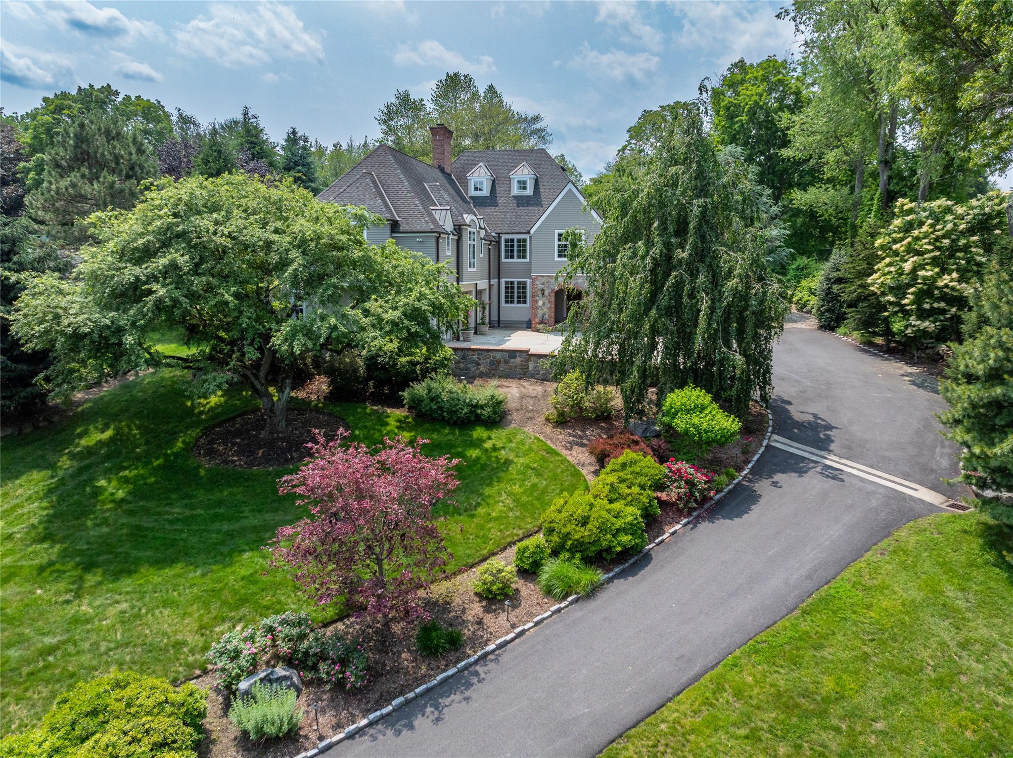 Welcome to this young, one of a kind, high-end custom Armonk home set on 1.14 acres of beautifully landscaped, lush grounds with curated specimen plantings, stone patios, and a built-in fire pit-ideal for both relaxation and entertaining. Inside, the home is flooded with natural light thanks to oversized windows and multiple French doors that create seamless indoor-outdoor living. Thoughtful architectural details abound, with bespoke millwork, raised panel moldings, and striking coffered ceilings enhancing the elegant aesthetic. The inviting family room impresses with a cathedral ceiling and dramatic floor-to-ceiling brick and stone fireplace. The chef’s kitchen is a delight, perfectly designed for both daily living and entertaining. A luxurious primary suite offers a peaceful retreat, complete with generous proportions and spa-like amenities—your own private escape. Additional highlights include an oversized three-car garage and impeccable, turnkey condition throughout. Located in the highly desirable Byram Hills School District and just minutes from town, schools, train, and major highways-this is Armonk living at its finest.