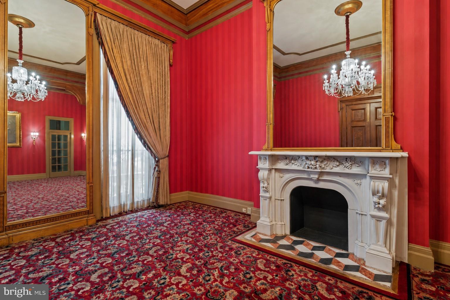 Previously used as a private physician’s office, Unit 14 occupies the parlor level and showcases 14-foot ceilings in the main rooms, with 11-foot ceilings in both the bath and a side room suited for a future kitchen. The space exudes a quiet grandeur, centered around an imported Italian marble mantel installed during a 1990s renovation that blended historic Mount Vernon character with refined European detail.Sunlight streams through 11-foot east-facing windows overlooking Saint Paul Street, filling the rooms with warmth and highlighting the tall doorways, decorative trim, and elegant proportions. While no kitchenette is currently installed, the thoughtful layout includes a room that can easily be adapted into one—offering a seamless path from professional use to residential living.The History: At the heart of Mount Vernon, 1118 and 1120 Saint Paul Street embody Baltimore’s architectural legacy. Designed and once occupied by George A. Frederick — the young prodigy behind Baltimore City Hall and the city’s park system — these brownstones reflect both history and craftsmanship. Now ,for sale within them are three distinct condominium units: dramatic parlor-level suites with soaring ceilings and ornate detail, alongside expansive lower-level spaces with flexible layouts and private entries. Together, they offer owner-users a rare mix of historic pedigree and practical adaptability in Baltimore’s cultural core.