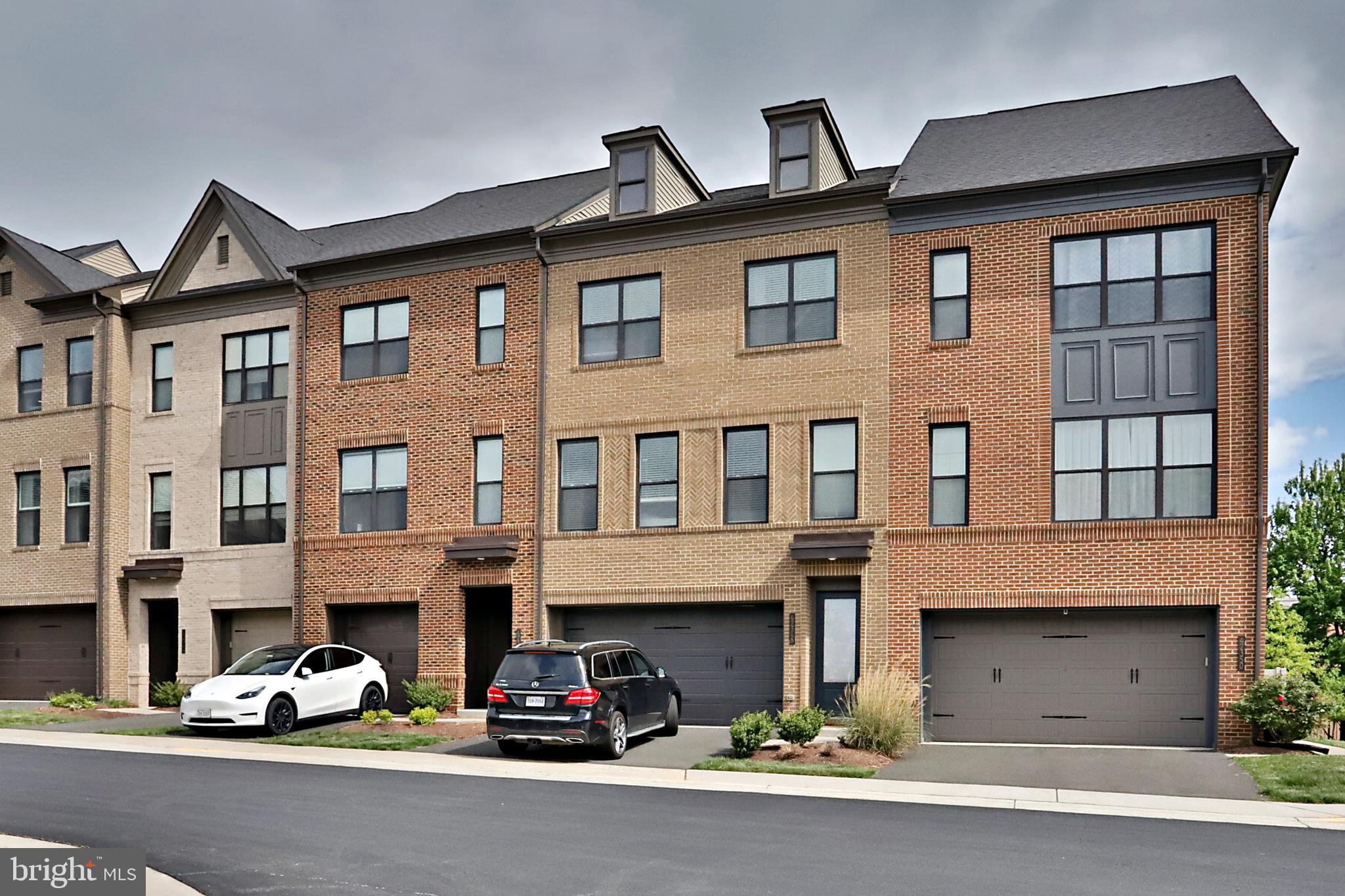 Perfectly positioned on a premium lot backing directly to Brambleton Town Center, this beautifully upgraded townhome offers the ideal blend of modern style, comfort, and convenience. With over $40,000 in thoughtful enhancements, every level of this home has been designed to elevate everyday living. Lower Level: The entry level features a private bedroom with a full bath—perfect for guests or a home office—along with a spacious recreation room that walks out to a quiet, fenced backyard. A rear-entry 2-car garage provides additional storage and functionality. Main Level:The open-concept main level is the heart of the home, showcasing wide-plank luxury vinyl plank flooring that flows seamlessly through the living, dining, and kitchen areas. The chef-inspired kitchen impresses with quartz countertops, crisp white cabinetry with chrome hardware, stainless steel appliances, and a large center island with stylish pendant lighting. Step outside to an expansive composite deck overlooking Brambleton Town Center—perfect for relaxing or entertaining. Upper Level:The serene primary suite features a walk-in closet and a spa-like bath with a walk-in shower and granite double vanity. Two additional bedrooms, a beautifully appointed hall bath, and a convenient laundry closet complete this level. Location & Community: Enjoy unmatched walkability to Brambleton Town Center, offering dining, shopping, the library, and entertainment at Regal Cinemas. Outdoor enthusiasts will love nearby parks, scenic trails, and playgrounds. Located just minutes from major commuter routes and Dulles International Airport, this home is also zoned for highly rated schools. Residents of Brambleton enjoy exceptional amenities, including over 20 miles of trails, multiple parks and tot lots, sports courts, and five community pools offering lap lanes, social spaces, and private party rentals.