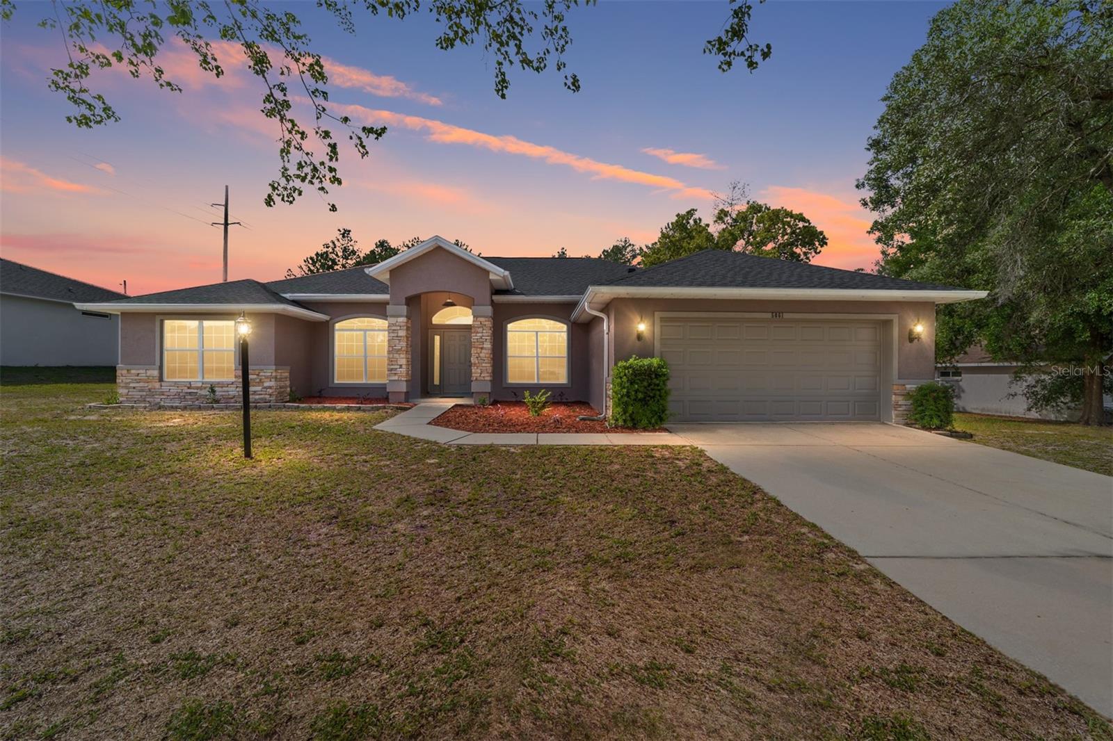 One or more photo(s) has been virtually staged. Welcome to this beautifully remodeled and updated 3-bed/2-bath home located in Kingsland Country Estates on a half-acre lot.  The home offers an open-concept layout with a split bedroom design, cathedral and tray ceilings, formal dining room, and completely remodeled kitchen with island, separate dining area, Epoxy countertops, pantry, and new stainless-steel appliances.  In addition, there is a bonus room that can be used as a home office or separate den.  The large primary suite has a walk-in closet and en-suite bathroom with double vanities, garden tub, and separate shower.  A spacious lanai just off the living room is perfect for outdoor living.  Roof was replaced in 2026, and the entire home (interior/exterior) was painted in 2026.  Additional features include new light fixtures.  This property is located just minutes from SR-200 offering lots of shopping, dining, and medical facilities.  Seller is offering a Broward Home Warranty for one year.