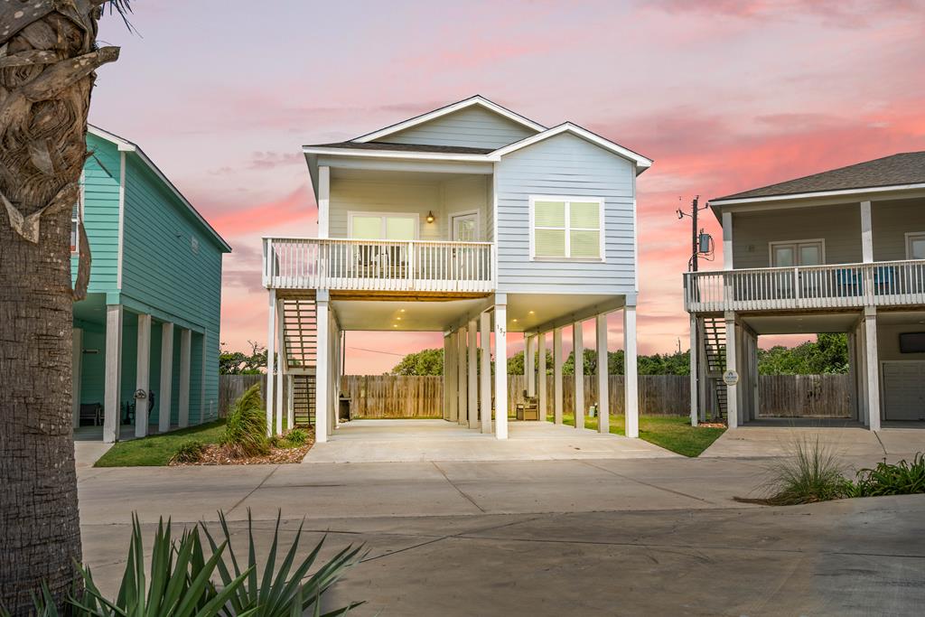 Coastal charm, thoughtful updates, and an unbeatable location come together in this beautifully maintained 3-bedroom, 2-bath home in the desirable Coral Reef Cottages community. Offered fully furnished, this island-style stilt home is ideal as a full-time residence, weekend getaway, or turnkey short-term rental investment. Nestled on a quiet street backing to a peaceful pond, you'll enjoy serene water views, abundant wildlife, and a short walk to the community pool. Inside, the open-concept layout features durable vinyl plank flooring, coastal-inspired dcor, and two built-in bunk areas that maximize sleeping space for family and guests. Downstairs, the spacious covered entertaining area is perfect for relaxing after a day on the water, while covered parking and plenty of room for your boat and trailer add everyday convenience. Coral Reef Cottages offers fantastic amenities including a resort-style pool, recently updated playground, and complimentary boat wash station. Ideally located just minutes from Cove Harbor Marina and boat ramps, you'll have quick access to world-class fishing and boating, while Rockport Beach, the Downtown District, shopping, dining, art galleries, and entertainment are all a short drive away. Whether you're looking for an income-producing investment or your own piece of the Texas coast, this move-in-ready home offers the perfect blend of comfort, convenience, and coastal charm.