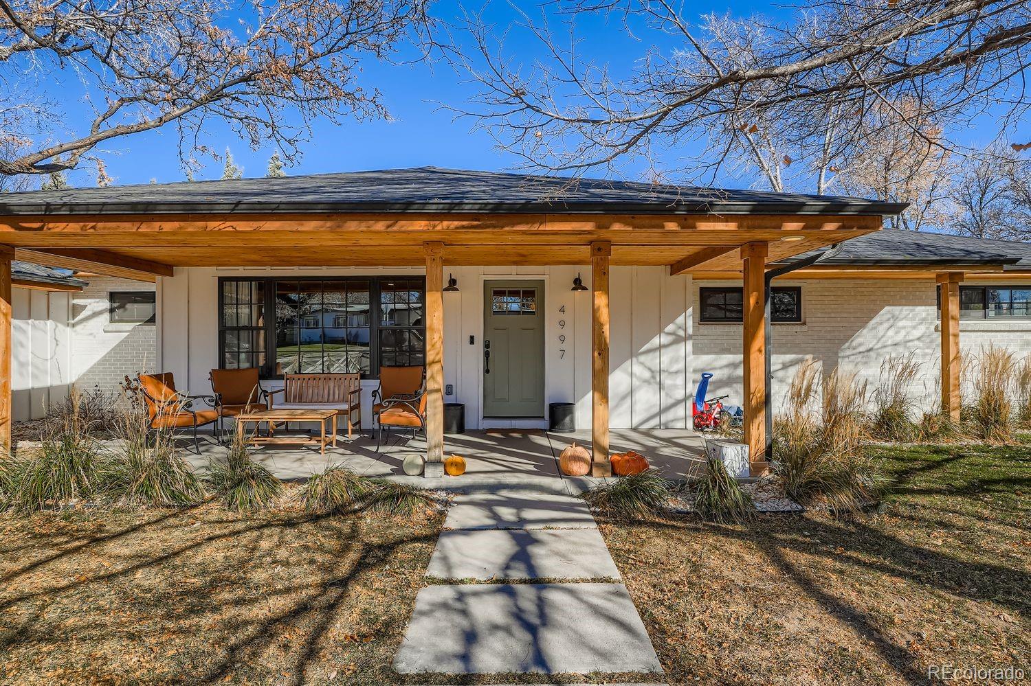 Nestled in the heart of Virginia Village, this beautifully reimagined mid-century ranch seamlessly blends timeless charm with thoughtful, high-end updates—delivering the open-concept layout today’s buyers crave. At the center of the home is a stunning new kitchen designed for both style and function: a generous island with seating, soft blue-gray shaker cabinetry, gleaming quartz countertops, and premium stainless-steel appliances. Flowing effortlessly into the bright dining and living areas, the space is anchored by a cozy fireplace and framed by oversized windows that flood the rooms with natural light. The private primary suite is a true retreat, featuring an expansive walk-in closet and a spa-inspired bathroom finished with classic, enduring design. Three additional well-proportioned bedrooms share a beautifully updated full bath, while a convenient laundry/mudroom connects directly to the attached two-car garage. Step outside to a rare 12,000-square-foot lot—fully fenced and offering both a spacious patio and lush lawn, perfect for play, entertaining, or quiet evenings under the stars. Move-in ready and ideally located just minutes from everything Denver has to offer, this turnkey ranch is the one you’ve been waiting for—elegant, effortless, and truly special.