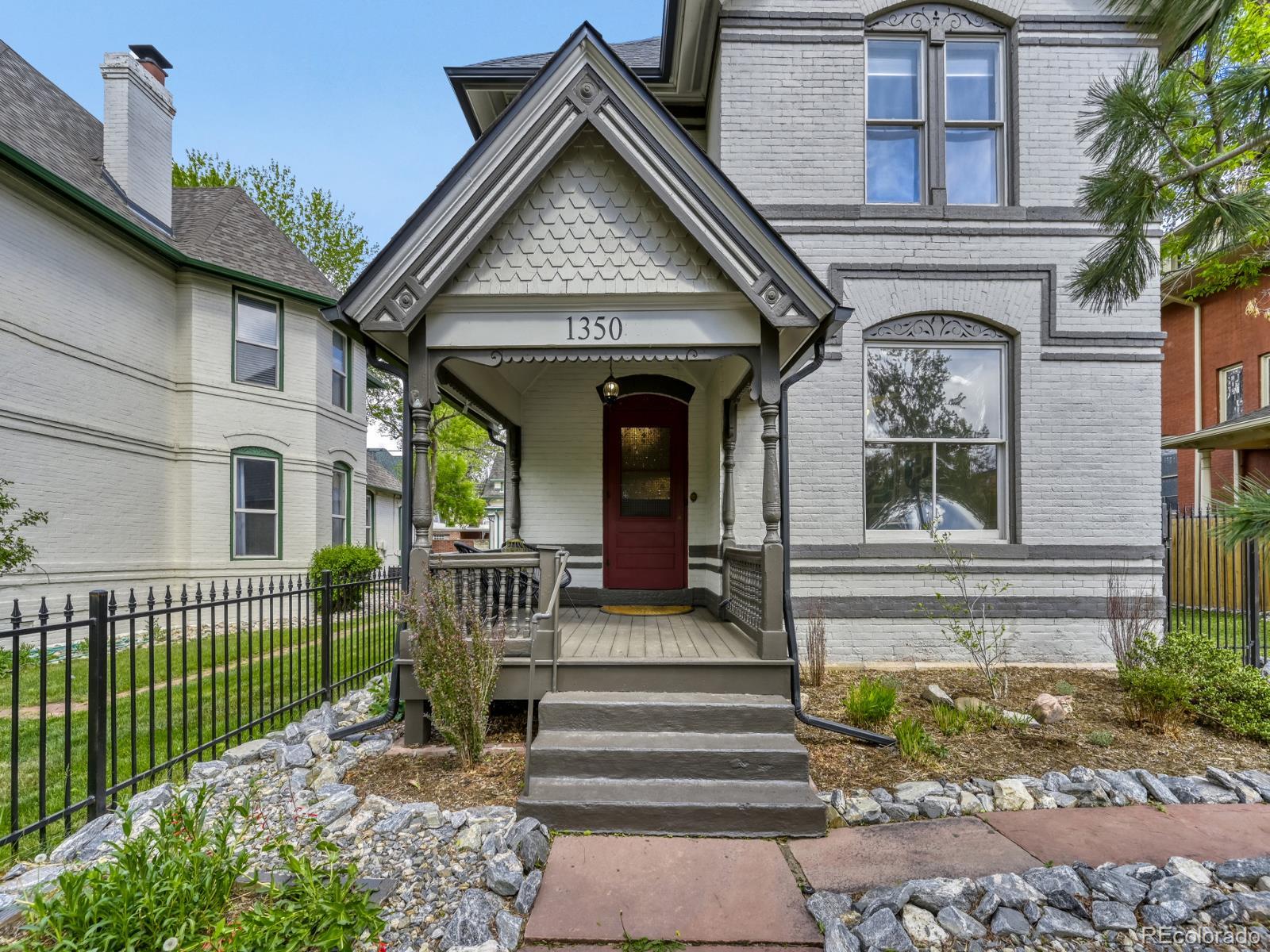 Beautiful, fully remodeled Victorian centrally located in the Cheesman Park neighborhood. This home is situated on a large double lot, within walking distance of Botanic Gardens, shops, restaurants and a short drive to downtown or Cherry Creek shopping areas. The covered front porch invites you into bright, spacious rooms with 10 foot ceilings, hardwood floors, original woodwork, and thoughtfully updated Victorian style finishes. The main floor includes the original parlor/office, living room, large dining area, powder bath, laundry, and a bonus room. The kitchen completes this floor with custom cabinets, high-end appliances, butler's pantry, and a covered porch for outdoor enjoyment. The original staircase takes you to the light-filled second level with a primary bedroom featuring exposed brick, a large updated  4 piece bath, and a private porch. Three additional bedrooms and a full bath complete this level. This home has an oversize 2 car garage along with an attached shed. An original cellar/storage space is accessible at the rear of the house.  Professionally landscaped yard with a gardening area.