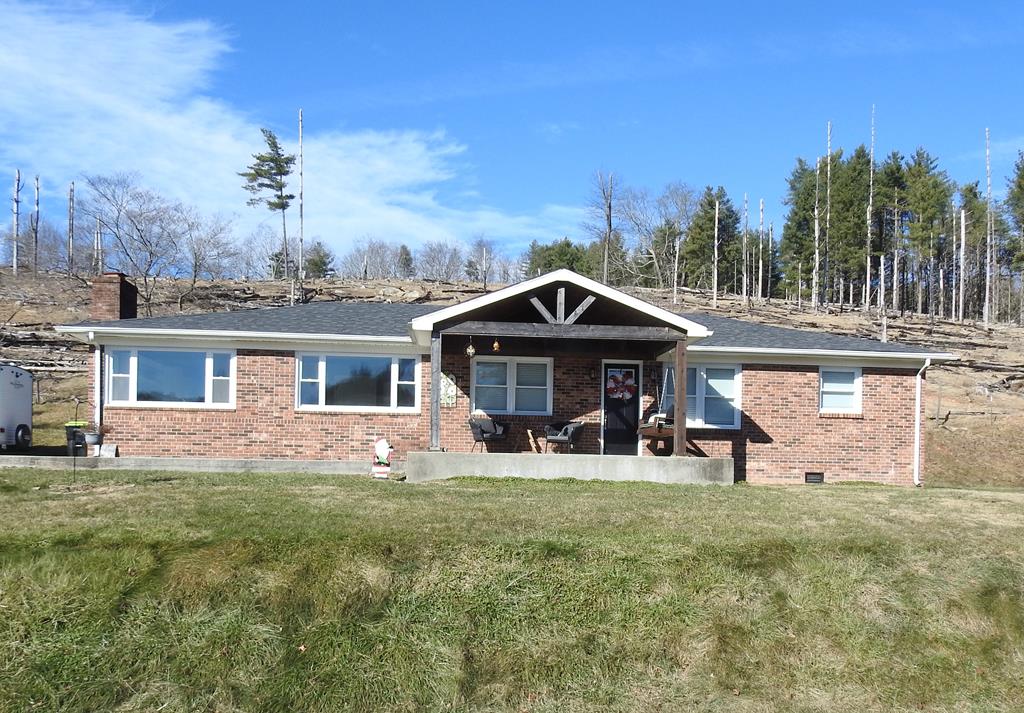 Welcome home to this classic brick ranch, perfectly situated in a calm country setting while still conveniently close to local amenities. This beautifully updated, move-in-ready home features 3 bedrooms and 2 full baths, offering comfort and functionality throughout. Step inside to find hardwood floors and a spacious eat-in kitchen, ideal for everyday living and gathering with family and friends. Outside, relax on the covered front porch, the perfect spot to unwind and enjoy the quiet surroundings. The property also boasts an outdoor fireplace, creating a wonderful space for entertaining or cozy evenings under the stars. Nature lovers will appreciate the additional wooded acreage, complete with a walkable pathway leading to a small hunting cabin, adding unique charm and versatility to the property. This home offers the best of both worlds—peaceful country living with modern updates and convenience. Move-in ready and waiting for you to make it your own.