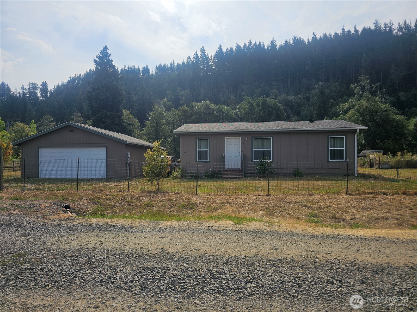 If you're looking for acreage, views, established fruit trees, timber, and room to garden and enjoy the outdoors, this property is worth a look! Discover the peaceful beauty of rural Lewis County at this charming 2022 864 sq ft modular home featuring a 2-bedroom, ¾-bath home situated on just under 8 acres in Glenoma. Partially fenced and offering beautiful territorial views, this property is a wonderful opportunity for those seeking space, privacy, and a connection to nature. The acreage features an impressive variety of established fruit trees, including four types of apples, pears, plums, cherries, figs, and hazelnuts, along with plenty of room for gardening. A seasonal creek adds to the property's natural appeal, while the property borders designated forest land and offers an abundance of marketable timber, including alder, cedar, fir, and maple. A detached 2-car garage provides excellent space for vehicles, equipment, hobbies, or storage. The property also includes a chicken coop and all appliances. The home is equipped with a kerosene mini stove, propane cooking, a tankless water heater, and a propane furnace. Conveniently located between Morton and Randle in the small community of Glenoma, you'll enjoy a peaceful country setting while still being close enough to take advantage of everything Lewis County has to offer. Road maintenance agreement with dues of $100.00 yearly. No CC&R's.