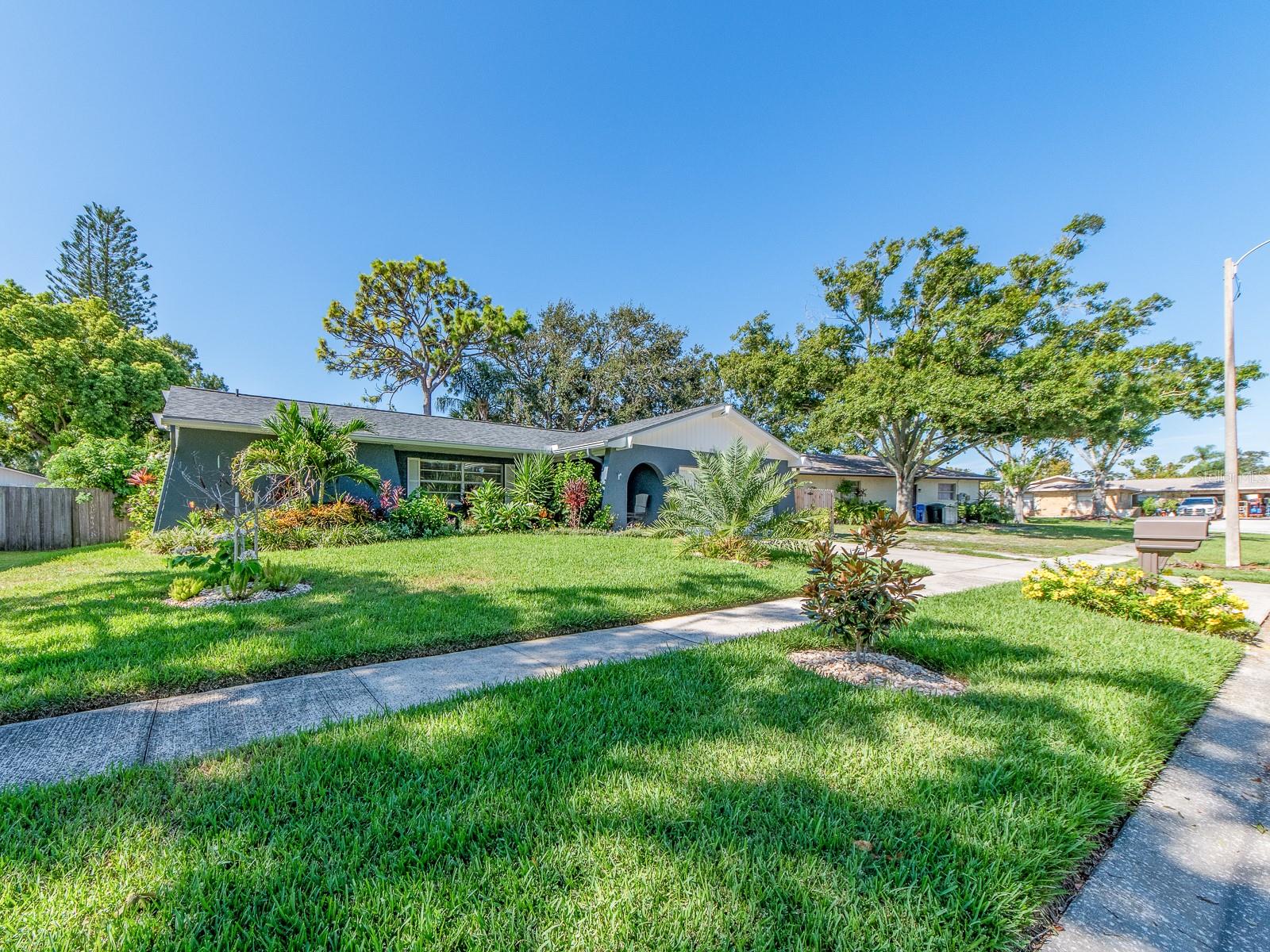 Location is everything! This property is not in a flood zone.  Come check out this 4 bedroom, 2 bath with a 2 car garage POOL home on a nice Cul-De-Sac street! Located in a North Pinellas County neighborhood situated between US 19 and Belcher Rd. which provides easy road access to many close by amenities such as great shopping, restaurants, banks, etc. Not far from Honeymoon Island State Park known for its beautiful beach and nature trails.  The floor plan offers a split bedroom layout.  Primary bedroom with sliding doors opening out to the lanai, has an en-suite bathroom and walk in closet. NEED an OFFICE? On the opposite side of the home, you have 3 rooms that can all be utilized as bedrooms or 2 can be with one used as an OFFICE. The kitchen overlooks the family room and looks out to the fenced in yard and pool.  Kitchen features white cabinets and newer appliances.  Home has a newer roof (2023),  heated salt water lagoon pool  (2023), And lush landscaping adds to the tropical enjoyment of the home.