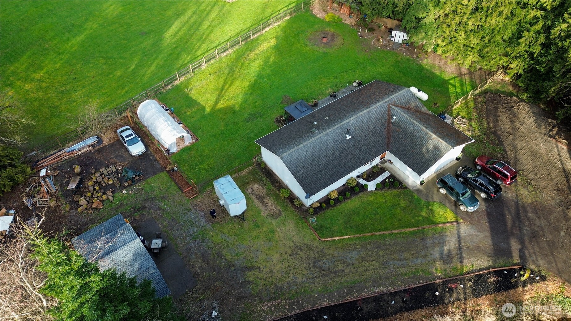 More room to live, play, and breathe without sacrificing convenience. This warm and welcoming 3-bed, 2-bath home offers about 1,526 sq ft on 0.74 acres, plus aple room for RV parking, a 2-car garage, and plenty of extra off-street parking for friends. The fully fenced backyard is ideal for dogs running free, playing safely, a pergola for shade, space to garden, a greenhouse, and calming mountain views that bring a sense of escape right at home. There’s room to add a play set, a fire pit area, raised garden beds, or enjoy a wide-open outdoor space.    Inside, the bright open layout floods the space with natural light, and the wood-burning freestanding fireplace makes the living room the gathering spot for everyone, whether it’s game night, cozy mornings, or a quiet evening in. A detached building has early ADU work underway (buyer to verify permits/requirements), offering exciting flexibility; finish it as an ADU or use it as a workshop, studio, office, gym, or creative space. Enjoy quiet country living near schools, trails, and everyday essentials—take a look and experience the difference.