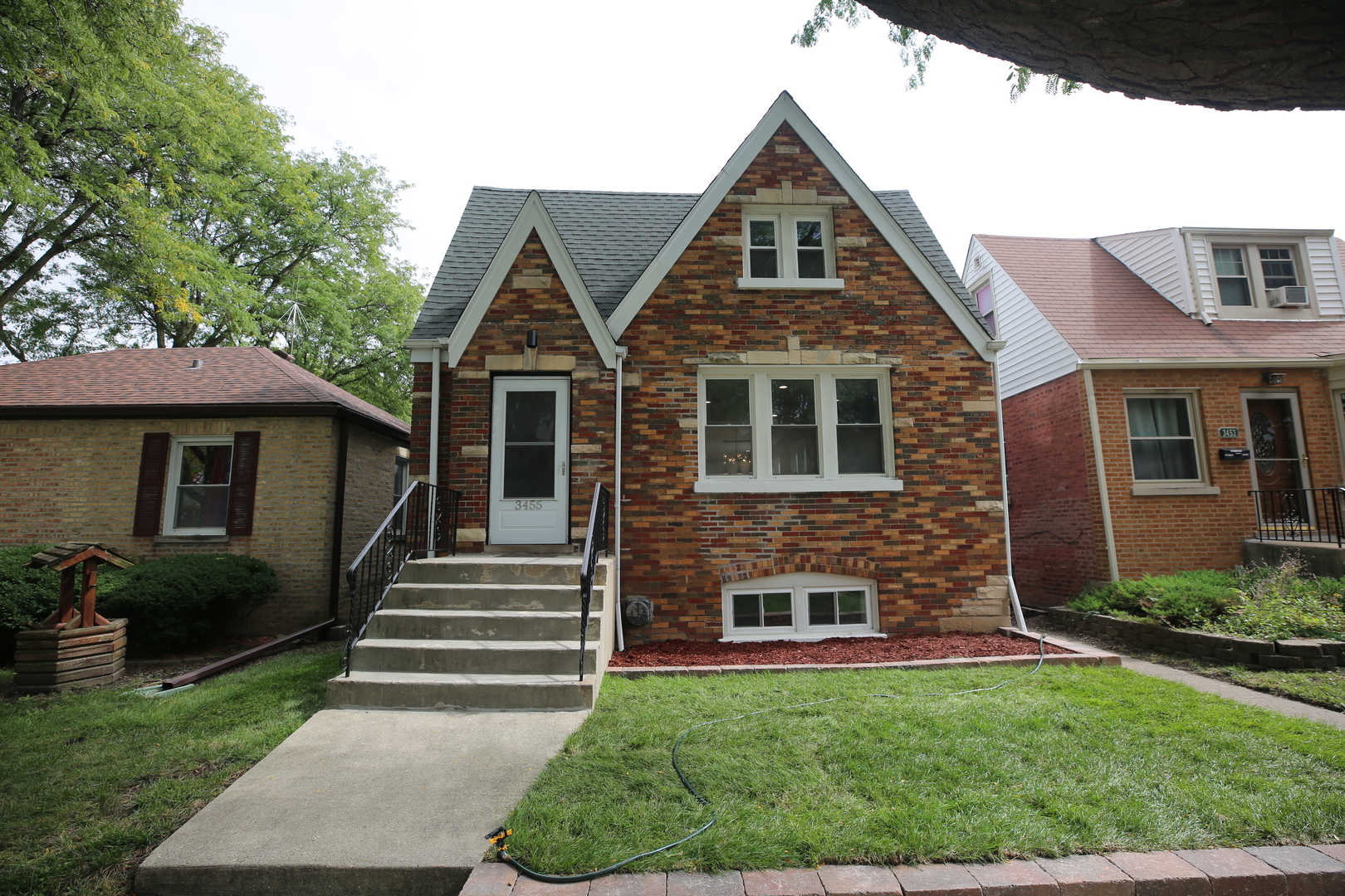 Beautifully remodeled brick home near desirable Hiawatha Park! Offering 5 bedrooms and 3 full bathrooms, this home pairs a modern design with generous living space. The open-concept main level connects the living room, dining area, and kitchen, with new hardwood floors throughout. The updated kitchen features premium white quartz countertops, Slim Dove White cabinetry, and a full suite of Samsung appliances.  Upstairs, the spacious primary suite includes a walk-in closet and an elegant private bathroom. The expansive finished basement offers flexible space for entertaining, recreation, or a home gym. A new HVAC system and water heater add to the home's appeal. Move right in and enjoy!