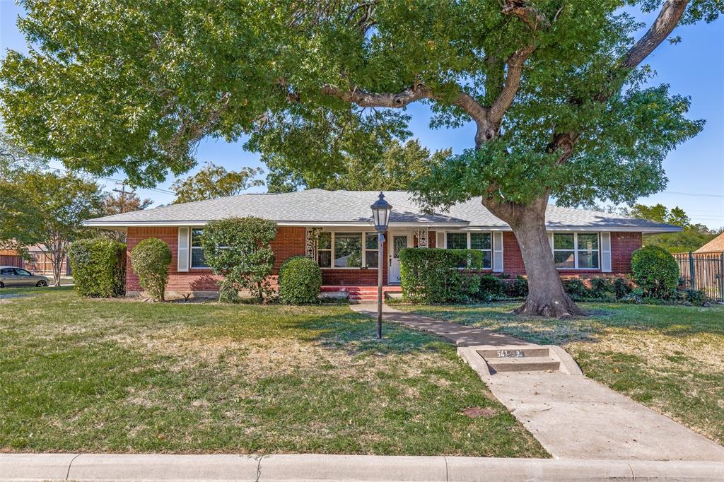 Nestled under a towering shade canopy in highly desirable Wynnewood North—one of North Oak Cliff’s most sought-after midcentury neighborhoods, this home combines timeless charm with crisp, modern updates. The layout offers the open living space, plus impressive room privacy.This spacious single-story residence features 4 bedrooms, 3 full bathrooms, and 2 living areas. Beautiful wood floors run throughout the open floor plan. The seamless open floor plan offers generous natural light and clean sightlines into the completely reimagined chef’s kitchen.The kitchen serves as an impressive focal point, centered around an oversized beautiful island with stark black-and-white quartz counters, under-cabinet lighting, sleek white shaker cabinetry, stainless steel appliances, a gas range with a chimney vent hood, and a chic mosaic tile backsplash. Vibrant ruby pendant lights add a retro pop, bridging classic vintage design with modern sophistication. The updated bathrooms decor is stunning with high end finishes, and staying true to the home's original theme.Set against Wynnewood North’s signature graceful streetscapes and mature trees, this home offers midcentury character paired with all the benefits of a modern renovation. Walk up to it's classic red brick, corner lot with big manicured front and side yard, up to a cute covered front porch. Roof was replaced in 2019, newer water heater, and most of the plumbing was updated to PVC.You will love the vibrant, cohesive neighborhood, working to become a designated conservation district. Enjoy urban convenience paired with suburban charm. Located just 10 minutes from Downtown Dallas, you're only a short drive to the vibrant energy of the Bishop Arts District, the Dallas Zoo, and the new Halperin Park deck park. Quick access to major thoroughfares makes commuting a breeze while keeping you connected to the very best of North Oak Cliff culture. See it and love it!