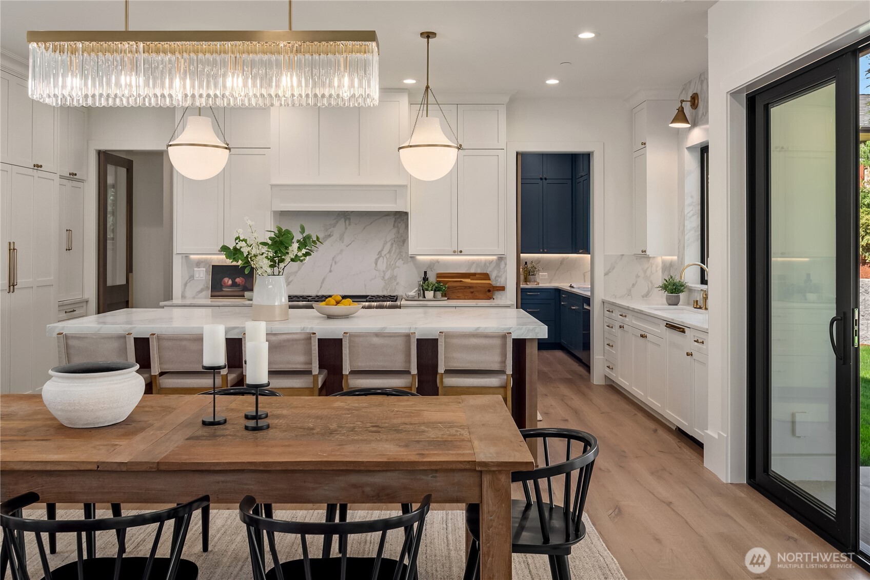 Marble backsplash frames the range in this gourmet kitchen