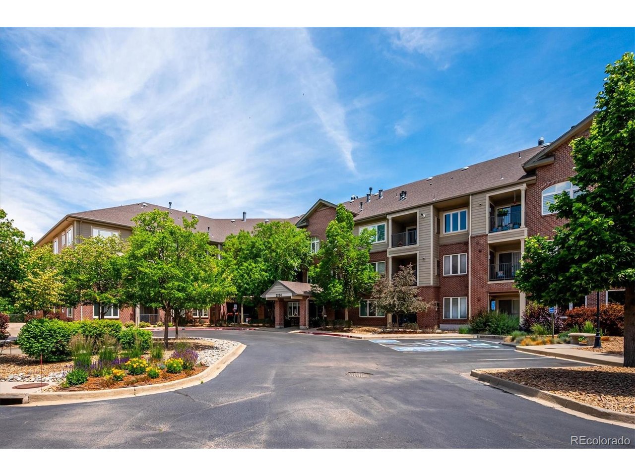 Top-Floor Living with Spectacular Views in Riverwalk's Premier 55+ Community! Enjoy breathtaking golf course and downtown Denver views from this beautifully updated residence ideally situated on the top floor of a secure, active-adult building. Thoughtfully upgraded throughout, this move-in ready home combines comfort, style, and low-maintenance living. The updated kitchen features granite countertops, designer tile backsplash, stainless steel appliances, a newer refrigerator and dishwasher, and a stove and microwave replaced just three years ago. Luxury vinyl plank flooring with premium cork underlayment extends through the living spaces, while plantation shutters throughout provide timeless elegance and privacy. Additional highlights include a tankless hot water heater, updated lighting throughout, and two ceiling fans for enhanced comfort. The spacious primary suite offers an updated bath with dual-sink vanity and LVP flooring with cork underlayment. The secondary bathroom has also been refreshed with a newer vanity and toilet. A rare bonus in the community, this home includes two deeded parking spaces conveniently located near the elevator (#64 and #89). Enjoy the vibrant Riverwalk lifestyle with easy access to walking trails, golf, dining, shopping, and community amenities, all while taking in some of the best views the community has to offer. Top-floor location, extensive updates, two parking spaces, and panoramic golf course and city views make this an exceptional opportunity in Riverwalk