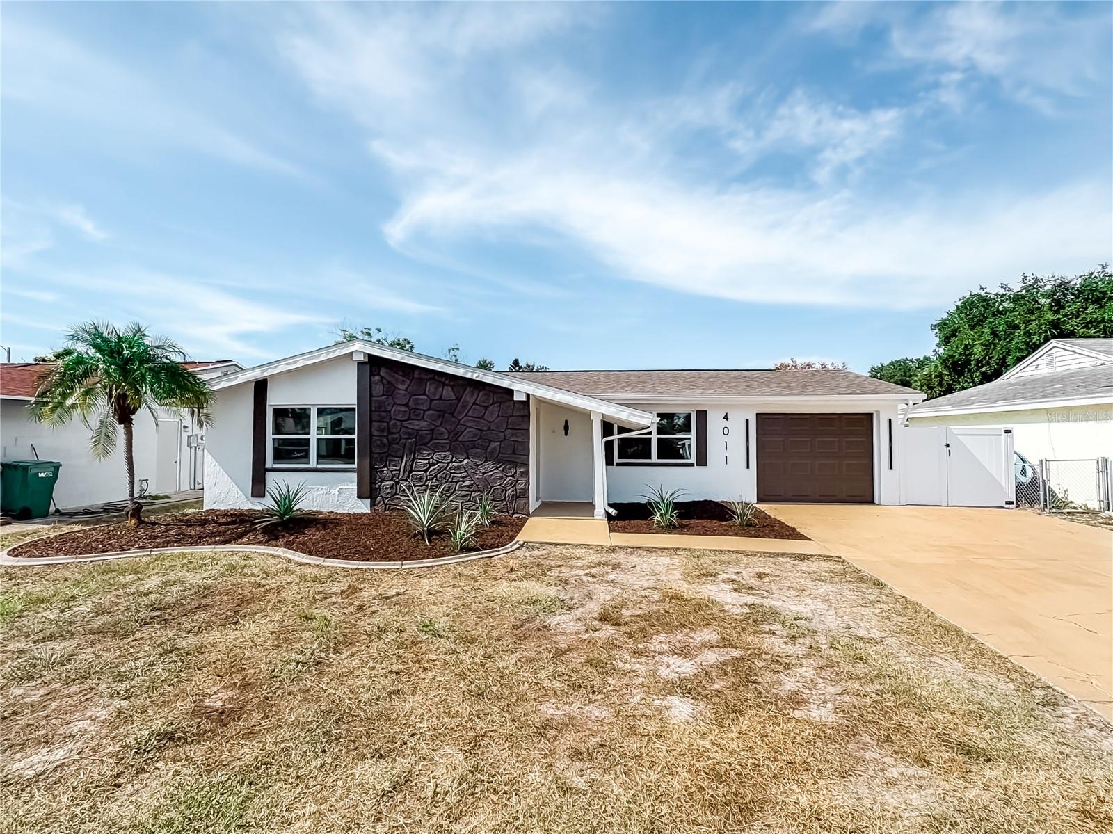Under contract-accepting backup offers. NO HOA. NO FLOOD ZONE. LOW TAXES. FULLY RENOVATED. LESS THAN 1 MINUTE TO US-19!Welcome to a beautifully renovated New Port Richey home where modern style meets peace of mind. Major upgrades include a NEW ROOF (2026), NEW A/C (2026), NEW WATER HEATER (2026), IMPACT WINDOWS & DOORS, and NEW GARAGE DOOR. Step inside to a sleek, modern interior featuring a spacious primary suite with private bathroom and an enclosed window-lined lanai, perfect for enjoying Florida living year-round. The home is also fully fenced with a vinyl fence and offers an unbeatable location just moments from US-19, with shopping, dining, and entertainment nearby. Updated. Modern. Convenient. Move-in ready. This one checks all the boxes—come see it before it's gone!