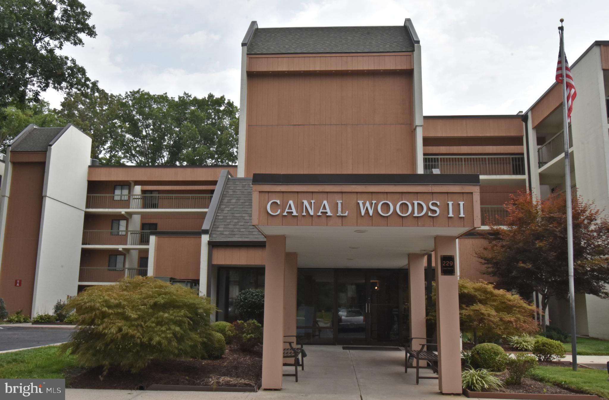 Don’t miss this wonderful opportunity to own a spacious home in the desirable Canal Woods II community, overlooking scenic Tony Tank Pond! Canal Woods II is an owner-occupied condominium community offering secure, locked entrances, elevator access, and well-maintained common areas.Step inside to a welcoming foyer that opens to a spacious living room and open dining area—perfect for everyday living and entertaining. The kitchen features granite countertops, a tile backsplash, ample cabinetry, and space for a breakfast table.The primary suite is a peaceful retreat featuring a private full bathroom with a tile shower and its own screened porch overlooking Tonytank Pond. An additional sun balcony/porch also offers beautiful pond views, providing the perfect place to relax and enjoy the scenery.Two additional bedrooms and a second full bathroom with a tile shower provide plenty of space for family, guests, or a home office.With its spacious layout, secure community amenities, elevator access, and beautiful views of Tony Tank Pond, this Canal Woods II home offers a wonderful combination of comfort, convenience, and waterfront scenery.