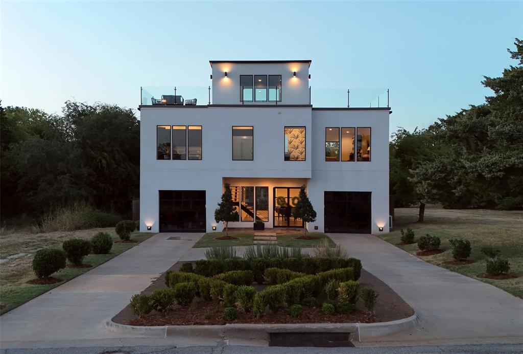 Minutes from downtown Oklahoma City, this striking multi-level modern residence offers three bedrooms, two-and-a-half bathrooms and 1,400+ square feet of second- and third-story outdoor living space. Two second-floor patios and a wraparound third-floor terrace with 360-degree views of Downtown Oklahoma City create incredible spaces to entertain and enjoy the skyline. The third-story terrace features a natural gas fire pit producing 200,000 BTUs of heat, and all elevated patios are finished with CoolTech Trex decking. The large, fully fenced backyard is an unexpected find this close to the city, featuring a heated pool with an oversized tanning ledge, heated hot tub, generous lawn space, sprinkler system and fire pit area. An imported Turkish marble courtyard adds another elevated touch. Inside, soaring ceilings, rich wood floors and oversized windows frame views of the pool. A custom-fabricated floating staircase with natural wood treads and black steel railings serves as a sculptural focal point. The kitchen features floor-to-ceiling cabinetry, beautifully veined quartzite countertops and matching backsplash, plus an oversized waterfall-edge island with integrated sink and bar seating. An eight-burner cooktop and double ovens are complemented by a butler’s pantry with additional cabinetry, counter space, built-in microwave and oversized built-in side-by-side refrigerator. The adjoining dining space opens through a three-panel sliding door to a private patio, while the generous living area includes a bar and opens to another large patio. The powder bath makes a memorable impression with botanical wallpaper, richly veined stone flooring and a sleek black vanity. From pool days to dinners on the patio and sunset views from the rooftop terrace - this one makes the most of every square foot, inside and out.