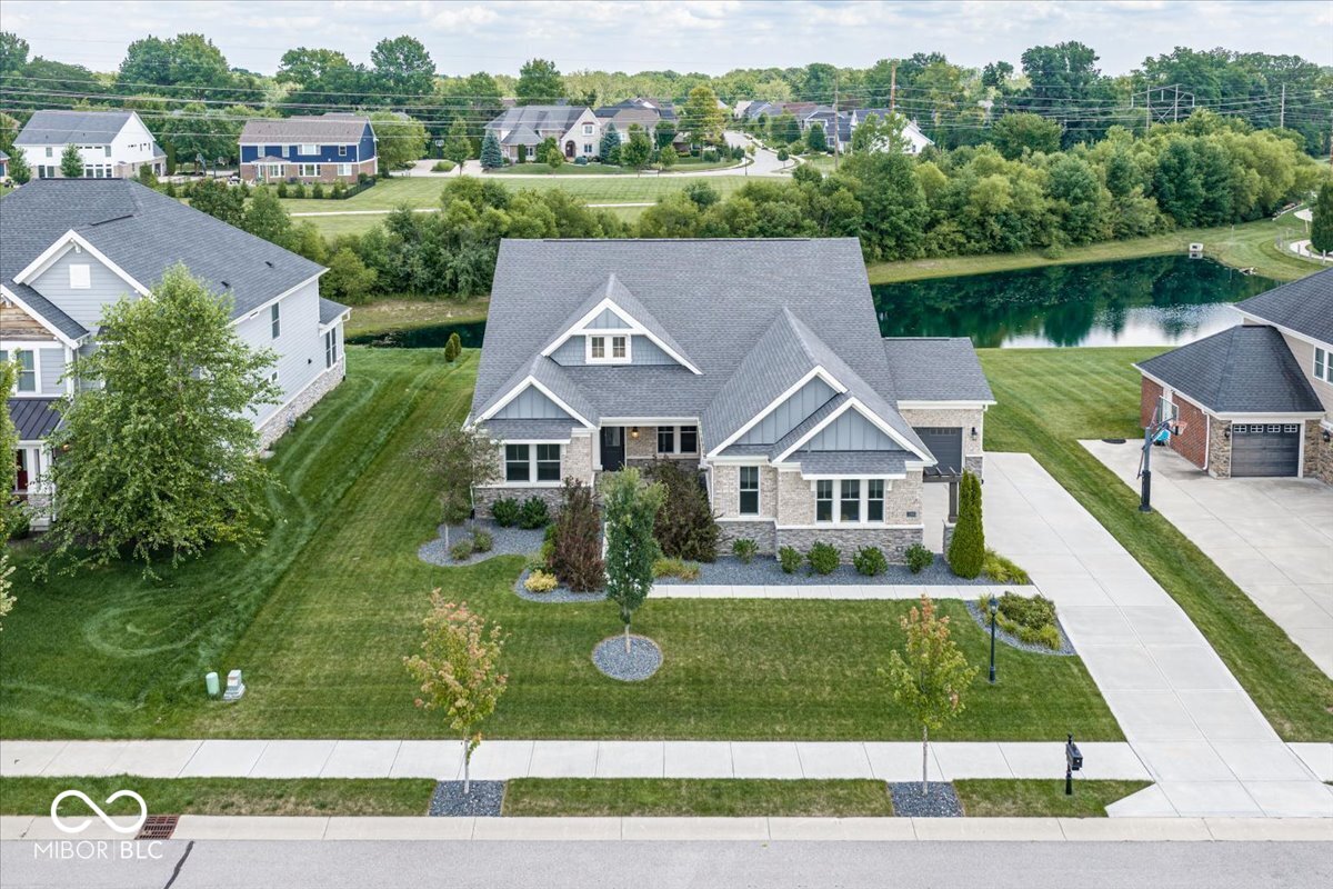 Modern design, flexible living space, and an exceptional Fishers location come together in this beautifully appointed Everett floorplan in Knoll at Thorpe Creek. Built in 2021 by Fischer Homes, the main level features engineered hardwood flooring, a dedicated home office, and a bright, open-concept living area anchored by a gas fireplace. The kitchen is designed for both everyday living and entertaining, with quartz countertops, tile backsplash, a large eat-in island, double ovens, a gas cooktop, and a vent hood. Upstairs, an additional living area provides valuable flex space for a media room, playroom, or second home office. The fourth bedroom and full bathroom also create an ideal private space for guests. A massive unfinished basement with a plumbing rough-in offers exceptional storage and endless potential for future living space, a home gym, theater, or recreation area.    Additional upgrades include an irrigation system, Kinetico reverse osmosis system, and Klipsch home surround sound. Located across from Thorpe Creek Elementary School and just down the street from Hamilton Southeastern High School, the home also offers convenient access to Geist Reservoir, Geist Waterfront Park, Geist Greenway, and Fishers District.