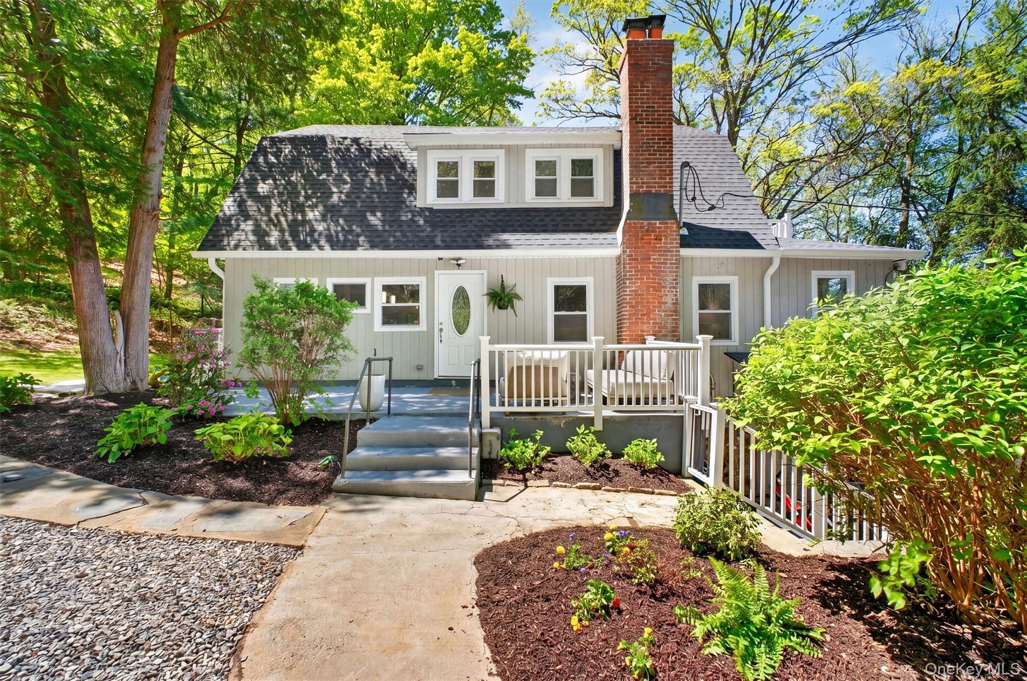 If you’ve been dreaming of a chic, nature-filled retreat with modern upgrades and the rare convenience of WALKING to the train, this is the one that captures it all. Tucked into a breathtaking .78 acre setting with sweeping mountain views, this picture-perfect Colonial—FULLY renovated in 2023—offers a rare blend of refined style and serene. Nature-filled living in the highly coveted Goldens Bridge community. This chic, light-filled residence feels straight out of a magazine, blending modern design with a backdrop of serene natural beauty. Step inside to a sophisticated open-concept layout featuring gleaming hardwood floors and thoughtfully curated finishes throughout. The stunning chef’s kitchen is the heart of the home, showcasing quartz countertops, stainless steel appliances, abundant cabinetry, a spacious center island, and designer lighting. Flowing seamlessly into a generous dining area with sliders opening to the private backyard and picturesque, bucolic grounds—ideal for effortless indoor-outdoor living. The inviting large living room is equally impressive, anchored by a beautiful wood-burning fireplace, and opens to an expansive four-season room wrapped in walls of windows, where tranquil views create a peaceful retreat year-round. On the opposite side of the home, a well-appointed entry/mudroom creates a refined yet practical space for storage and organization, accompanied by a beautifully updated powder room with integrated laundry. Upstairs, you’ll find two generously sized bedrooms connected by an updated Jack-and-Jill bath. The primary suite offers 2 walk-in closets and direct access to a private deck—an idyllic spot for morning coffee or evening relaxation. The second bedroom also offers two walk-in closets. The lower level offers exceptional versatility with two separate entrances and features a living area complete with a wet bar, full bathroom, and an additional room ideal for extensive storage, guest suite, home gym, or home office. Extensive upgrades include a new roof, full interior renovation, central air, updated heating system with smart thermostats, recessed lighting, new hot water heater, boiler, and patio—making this home truly move-in ready. Enjoy exclusive lake rights to Timber Lake, just a short walk away, offering swimming, boating, and a vibrant community lifestyle with amenities such as a lifeguarded beach, basketball court, volleyball court, soccer field, baseball field and playground. Also offering a well-known 95 year old summer camp and a charming community barn hosting seasonal events such as line and folk dancing. This special setting/community is further enhanced by scenic hiking trails woven throughout the surrounding area. From kayaking and paddle boating to summer barbecues and endless outdoor recreation, this is a lifestyle that truly feels like a getaway every day. You have the ideal situation with this home having 17 acres of forever wild land/protected green space right behind the house. A rare opportunity to own a sophisticated, turnkey home in one of the area’s most sought-after lake communities. John Jay School District. Major highways, shopping centers, and the Goldens Bridge train station just down the road further enhance this spectacular find! Enjoy your time viewing this completely renovated LOVELY home and discover the perfect blend of nature, community, and lake living.