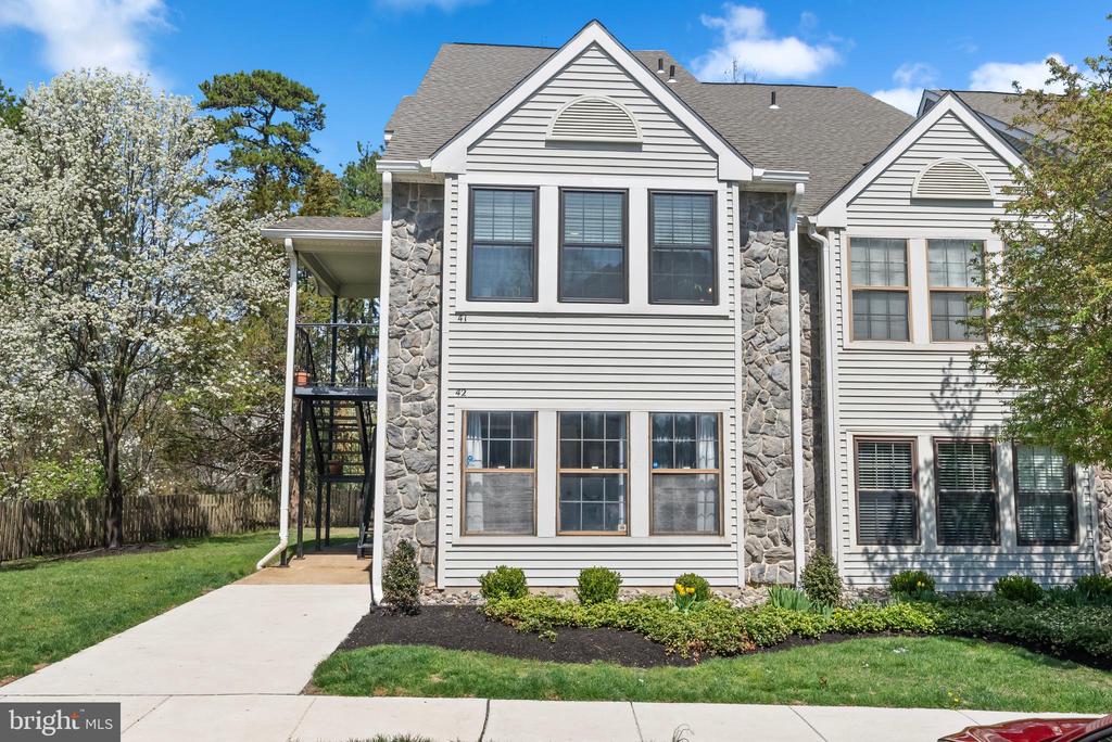 Welcome home to Oak Hollow, located within Kings Grant. The Kings Grant community features great amenities including a community pool, tennis courts, lake access, and The Links Golf Club - a public golf course right down the street! This two bedroom two bathroom second floor lofted unit features all brand new windows, newer HVAC, and a light and bright feel. As you walk in, the main bedroom is spacious and filled with tons of natural light. This room features a walk in closet, as well as two other standard closets. There is an attached full bathroom that features a newer vanity, toilet and flooring. The family room has a vaulted ceiling - which is open to the loft area. The kitchen is updated and features solid Oak cabinets, stainless steel appliances, and a newer dishwasher. There is a covered deck on this level, with additional outside storage. Upstairs, there is another bedroom, which has another deck area. There are two more closets, as well as a massive walk in closet. There is another full bathroom, which is completely renovated. This is truly not a unit to miss - come check this out!