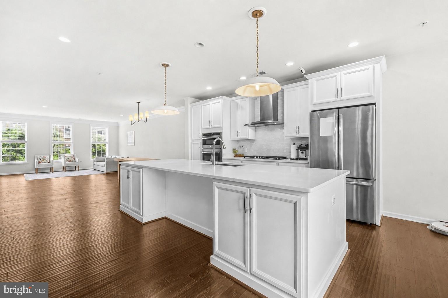 Welcome home to this stunning Denham model in sought-after Buckingham at Loudoun Valley! Offering 2,452 square feet of beautifully designed living space, this upper-level townhome-style condo combines modern luxury, smart-home convenience, and an open-concept floor plan filled with natural light. The heart of the home is the gourmet kitchen featuring white cabinetry, stainless steel appliances, gorgeous white quartz countertops, a stylish backsplash, and an oversized center island with upgraded pendant lighting—perfect for entertaining. The spacious living and dining areas flow seamlessly together and are enhanced by upgraded chandeliers in the dining room, breakfast nook, and stairways. Upstairs, retreat to the expansive owner's suite featuring a large walk-in closet and a spa-inspired bath with a seamless glass shower, oversized soaking tub, and elegant finishes. Two additional generously sized bedrooms, a full hall bath, and convenient upper-level laundry complete the bedroom level. Thoughtful upgrades include smart locks on the front and rear doors, Kasa TP-Link smart switches throughout, and an Ecobee smart thermostat. Fresh designer finishes, abundant sunlight, and spacious rooms make this home truly move-in ready. Residents enjoy access to Loudoun Valley's exceptional amenities, including pools, fitness centers, parks, trails, tennis and pickleball courts, and playgrounds. Ideally located just minutes from Walmart, Target, Harris Teeter, Brambleton Regional Park, Legacy Park, Hal & Berni Hanson Regional Park, Brambleton Town Center, the Ashburn Metro Station, Dulles Greenway, and major commuter routes. This exceptional home offers the perfect blend of style, comfort, convenience, and low-maintenance living in one of Ashburn's most desirable communities.