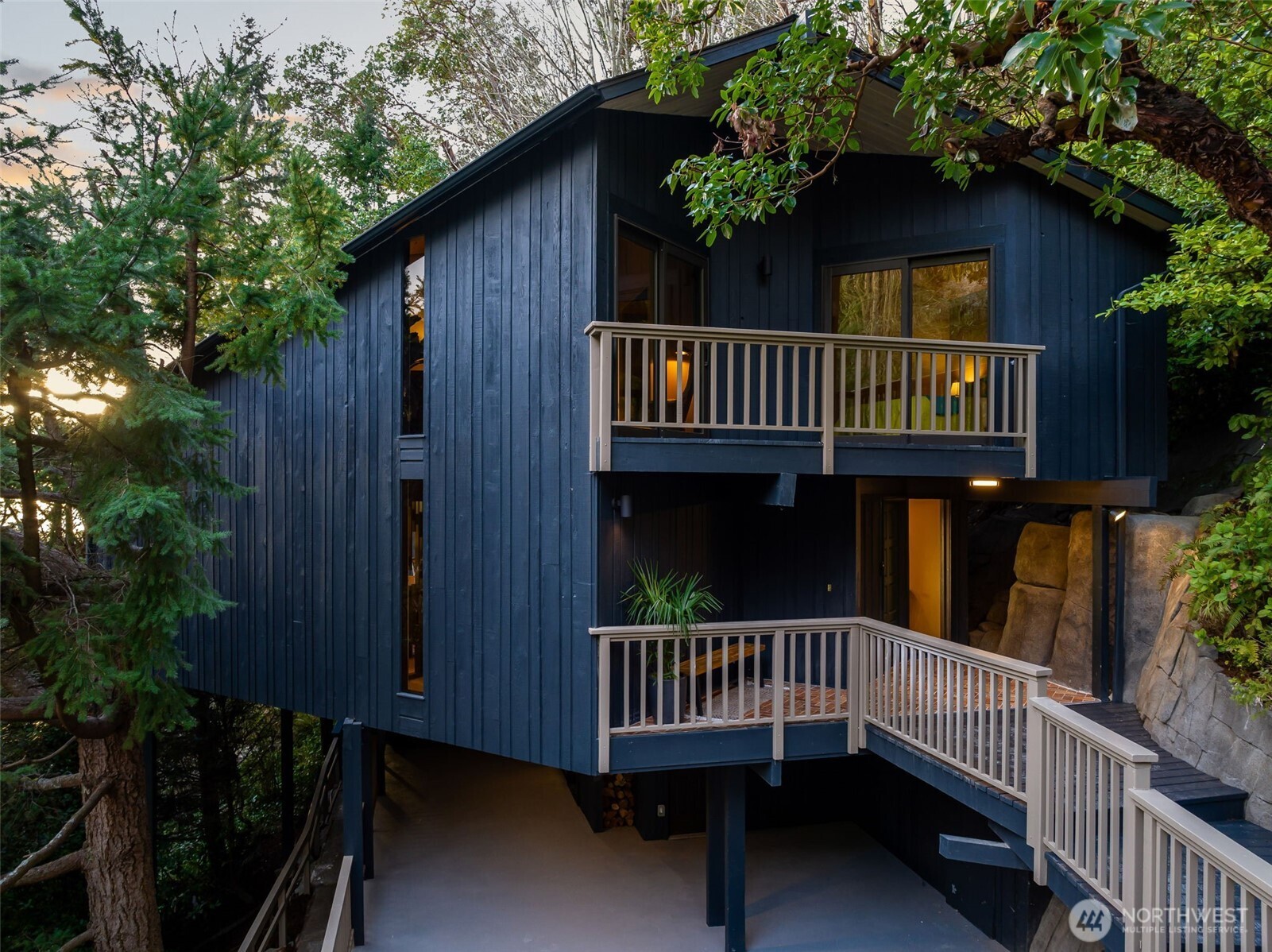 A rare 1969 Northwest Contemporary– architect-designed and completely reimagined in 2026. Set on a lush 12,800 sq ft lot in a private enclave of just 15 homes, this 3,360 sq ft retreat offers sweeping Puget Sound and Vashon Island views from the main living spaces and primary suite. The main level is designed for connection and light: A dramatic kitchen with a 10-foot island, Hestan appliances, and 10-foot bifold doors opening to a view deck. Vaulted ceilings and expansive glazing in the kitchen, living, and dining areas bring the outdoors in. The upper floor primary suite is a true escape, featuring a spa-like bath with skylit shower, soaking tub, and refined finishes throughout. Completing the upper floor are two additional bedrooms with sliding doors to a peaceful balcony, a spacious tiled bath, and laundry area. Downstairs find a media-ready family room and secluded hot tub deck. Every system and surface has been thoughtfully updated, including a new heat pump for A/C and energy-efficient heating, designer lighting, and curated materials. Adding to the enjoyment are shared community amenities including a park next to the home, and a spectacular beach lot for picnics and kayaking just a short walk down the private road. A rare blend of architectural integrity, privacy, and modern comfort– minutes to Seattle, yet worlds away.