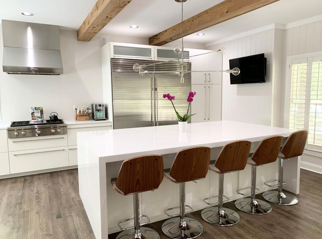 Exquisite 5-Bedroom Home with Modern European Flair and Stunning Views!  Located at the back of a quiet cul-de-sac in one of the most sought-after neighborhoods, this beautifully updated 5-bedroom, 3.5-bathroom home (plus a 1/1 detached garage apartment!) offers the perfect balance of modern elegance, exceptional functionality, and serene surroundings. Set on a spacious, wooded 1.14-acre lot, this property not only boasts a luxurious interior but also provides an ideal location with Brookwood School less than 4 minutes away. Gourmet Kitchen & Living Areas: Step into the heart of the home, where a Modern European kitchen steals the show. Featuring top-of-the-line appliances including full-sized Subzero fridge/freezer, Wolf steam and convection wall ovens, Wolf gas range with griddle, Bosch convection oven/microwave combo, and Cove dishwasher, this kitchen is every chef's dream! Pecky cypress beams and painted tongue-and-groove details enhance the space with rich textures, while quartz countertops and a stunning 9x5 cascading quartz island provide plenty of prep space. Two oversized 4x6 windows bring in plenty of natural light and capture the beautiful views of the surrounding landscape. The living room, with its soaring vaulted tongue & groove ceiling, is equally impressive offering a cozy ambiance with a wood-burning fireplace (gas starter), perfect for evenings at home. Built-in bookshelves provide elegant storage, enhancing both form and function. The home has been meticulously updated with modern interior lighting, fixtures, switches, and fans throughout. Bonus Room & Master Suite:  Enjoy an additional spacious 1/1 apartment (460 sqft) above the detached garage. This versatile space is finished with real wood plank paneling and includes a fully renovated bathroom and LVP flooring making it ideal as a guest suite, media room, home office, or exercise room. The master suite is a sanctuary, with a separate sitting room or office area, built-in bookshelves, and a beautifully appointed bathroom that boasts a custom-built floating vanity, free standing tub for two, oversized walk-in shower with rain can, and closet with custom built-in drawers & shelving. Outdoor Living & Grounds: Step outside to the newly updated back deck with cables that wraps around the living area, offering a seamless transition to the lush, private backyard. Enjoy outdoor living with front and back porches, a stream running at the back of the property, and easy access to the pool and clubhouse just up the street!  Extra Features & Amenities: This home includes a whole house water softener system, reverse osmosis drinking water filtration system, and encapsulation with dehumidifier to ensure comfort and quality. The climate-controlled storage in the garage features wall-mounted bike racks and custom cabinetry, while the wired workshop (14X16) provides ample space for all your lawn equipment and power tools. Special Updates: A new roof (2018), exterior paint, new carpet in upstairs bedrooms, and new shed ensure that this home is as functional as it is beautiful. The bar area has been updated with a sleek quartz countertop and new cabinet doors making it perfect for entertaining. This stunning home truly combines luxury, practicality, and beauty. With its meticulously maintained interiors, exceptional location, and breathtaking surroundings, it is sure to be the perfect retreat for its next owners!  Sellers are licensed Realtors in the state of GA #369599 & #391145