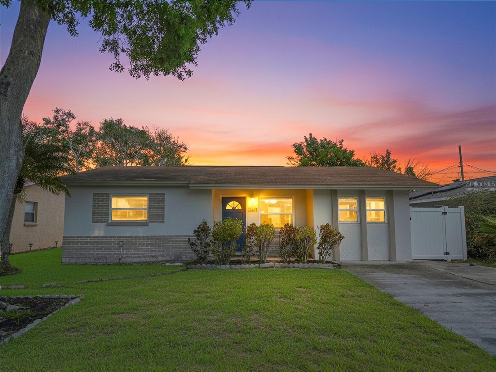 One or more photo(s) has been virtually staged. Welcome to this charming 3-bedroom, 2-bathroom POOL HOME located in the heart of St. Petersburg, Florida. Built with solid BLOCK CONSTRUCTION, this home offers the perfect blend of indoor and outdoor living spaces. The freshly painted exterior and welcoming ceramic-tiled front porch create the perfect place to relax and enjoy the Florida lifestyle. Inside, the home features NEW luxury vinyl flooring throughout and a freshly painted interior, giving the space a clean, modern feel. Blinds and ceiling fans are installed throughout the home for comfort and convenience. The spacious bedrooms offer plenty of room to unwind, while the guest bathroom has been updated with beautiful new travertine flooring. The kitchen is both stylish and functional, featuring light maple cabinetry, a stainless refrigerator, and a modern checkerboard backsplash that adds a contemporary touch. Just off the kitchen is a convenient BUTLER’S PANTRY that provides additional storage and prep space. PLUS an indoor laundry area adds everyday practicality. From the dining room, step outside to a covered patio that overlooks your PRIVATE BACKYARD OASIS. The sparkling in-ground swimming pool features a beautiful PebbleTec finish and is surrounded by tropical landscaping with palm trees that create a peaceful retreat. The backyard is fully enclosed with a white PVC privacy fence and also includes a charming barn-style shed with electricity, perfect for storage or hobbies. Outdoor living is truly exceptional here, with both a covered patio and a screened-in patio that includes air-conditioning and additional vinyl windows, allowing you to enjoy the space comfortably year-round. Additional highlights include double-pane insulated windows throughout the home, an updated electrical panel, and an extra-wide driveway that comfortably accommodates numerous vehicles. Centrally located in St. Petersburg, this property offers proximity to restaurants, shopping, movie theaters, parks, and convenient interstate access, making it easy to enjoy everything the area has to offer.