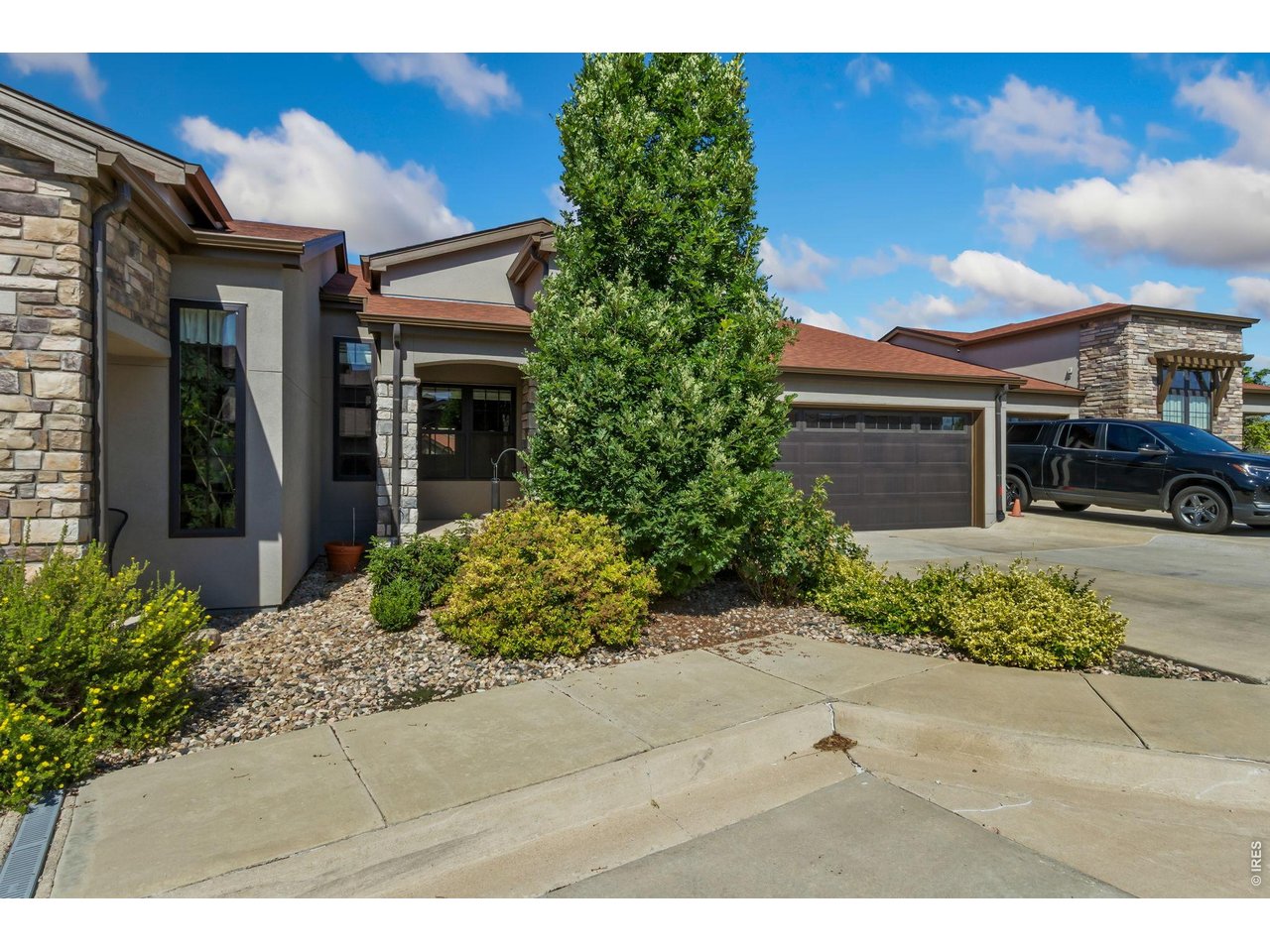 Located in the highly desirable Bella Vira neighborhood at the base of the foothills in West Fort Collins, this beautifully maintained ranch-style patio home offers miles of hiking and biking trails right outside your door. The wide-open floor plan features beautiful wood floors throughout much of the main level. The kitchen boasts high-end cabinetry, quartz countertops, a gas range, and all stainless steel appliances are included. The spacious primary suite captures beautiful foothill views and offers a walk-in closet, dual vanity, and a large walk-in shower. The professionally finished basement adds a generous family room, wet bar with refrigerator, third bedroom, 3/4 bath, and abundant storage. Relax on the covered front porch or enjoy the inviting deck, perfect for outdoor entertaining. Complete with a finished 2-car garage, this low-maintenance home combines comfort, style, and an exceptional West Fort Collins location.
