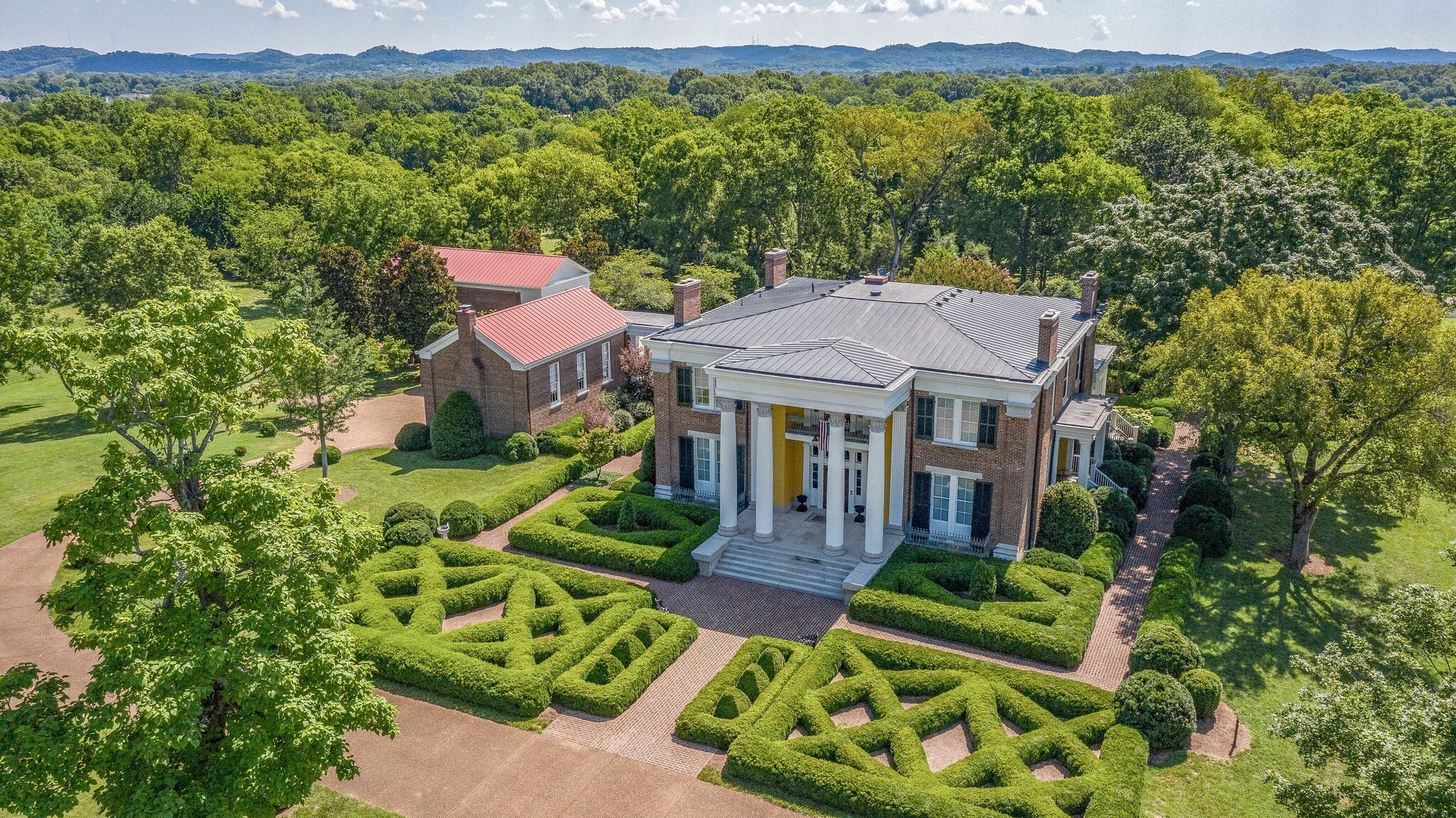 Step into the elegance of 1858 with this historical Greek Revival home, meticulously restored to reflect its original grandeur. Nestled on 66 acres, this property combines historic charm with modern luxuries. The current owners have thoughtfully added a variety of amenities, including a Guest House/Pool House, Carriage House/Recreation Room, and two barns. The estate also boasts two gated entries, a picturesque gazebo, a stunning cast iron fountain, and beautifully landscaped grounds that feature lush boxwood gardens. Inside, the "hobby room" serves as a cozy first-floor sitting area, while the "den" refers to a charming first-floor library. The third floor square footage refers to the separate Carriage House building, providing additional space and versatility. This property is a true masterpiece, blending historical authenticity with contemporary comforts. No Sign in Yard.