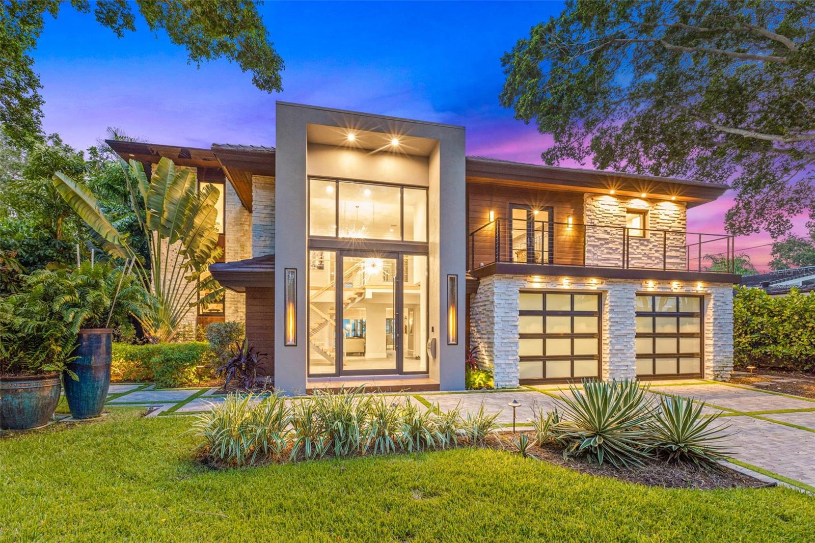 Breathtaking Waterfront Living on Iconic Brightwaters Blvd NE in Snell Isle!! 1365 Brightwaters Blvd is located on one of the most coveted blocks in St. Petersburg, this exceptional residence offers unobstructed views of downtown and the St. Pete Pier and sits on deep, protected sailboat water—ideal for boaters and water lovers alike. A striking modern design, this home has been completely redesigned to showcase a bright, open layout with multi-level living and expansive views from nearly every room. 
The main living area features soaring 14-foot ceilings and an open-concept great room perfect for entertaining. At the heart of the home, the designer kitchen is equipped with top-of-the-line appliances, an oversized island with bar seating, and a sleek butler’s pantry offering extensive storage, laundry facilities, and elevator access. A custom, temperature-controlled glass wine room adds an elegant and luxurious touch, while a private home office offers a quiet space to work or study. The lower level offers a versatile guest suite with its own living and dining space, a full bath, plus an additional guest bedroom with an en suite. A wet bar connects this level to the expansive outdoor entertainment area, ideal for hosting guests, providing in-law accommodations, or creating a private retreat for college-age children or a nanny. The primary suite is thoughtfully positioned on its own level for maximum privacy and features stunning water views from its private balcony. The en suite bathroom is a spa-like haven, with floating soaking tub, dual vanities, a glass-enclosed shower, and bespoke designer finishes. The walk-in closet has been fully customized with built-ins and a central lingerie island.
Step outside to your ultimate outdoor sanctuary—whether you're sunbathing on the upper deck, sipping your morning coffee while watching dolphins play, or entertaining poolside in the covered, climate-conscious swimming area. The dock is equipped with a 10,000 lb boat lift, making it easy to explore downtown St. Pete by water in under 10 minutes or venture to Tampa Bay and the Gulf beaches within a half hour.
This location is truly unmatched—just minutes from vibrant downtown St. Petersburg, where you can walk, bike, or golf cart to waterfront parks, award-winning restaurants, charming cafés, world-class museums, galleries, and the historic Vinoy Resort and Golf Club. Experience luxury living in one of the most sought-after waterfront neighborhoods in Tampa Bay—Snell Isle.