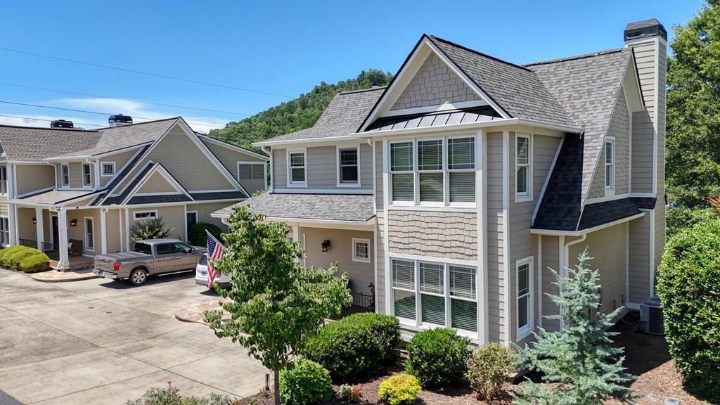 Completely updated Lake Chatuge craftsman home with deeded boat slip & exceptional community amenities. Just minutes to Hiawassee, this beautifully upgraded 2BR/2.5BA residence offers one of the best values on Lake Chatuge - featuring shared long lake frontage, a deeded slip at the community marina, and a thoughtfully refreshed interior that feels like new. The owners have transformed this home with modern finishes and smart improvements throughout: brand-new roof, stainless steel appliances, updated flooring, two new HVAC systems, and a stunning screened porch with sliding panels for true four-season enjoyment. The open floor plan includes a dining area, breakfast bar, and a striking two-story great room with fireplace - creating a warm, timeless atmosphere ideal for relaxing or entertaining. A convenient coffee bar and several versatile flex rooms give you space for a home office, media room, hobby space, or additional guest accommodations as needed. Located close to the shoreline, the property also includes a detached, oversized 1-car garage with new roof and abundant storage. The intimate 8-home private community offers one of the most affordable ways to experience Lake Chatuge living, complete with a marina, boat ramp, pavilion, fire pit, and scenic common areas along the water's edge. Move-in ready, beautifully updated, and set in one of the most desirable lake communities - this lake home is truly a must-see.