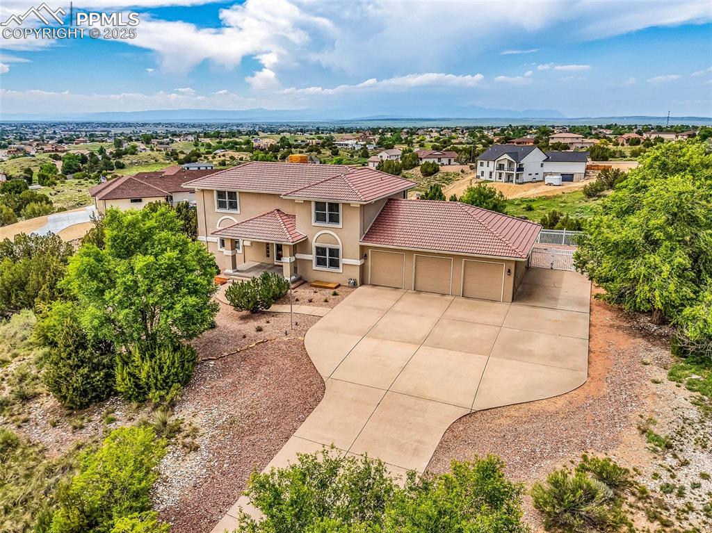 SINGLE OWNER home in IMMACULATE condition with MILLION DOLLAR VIEWS! This exceptionally maintained 5-bedroom, 4-bath home in the Liberty Point area of Pueblo West. Sitting on 1.12 acres, this spacious 4,575 sq. ft. residence built by THE DRAWING ROOM offers breathtaking mountain and lake views, modern upgrades, and a seamless blend of elegance and functionality. Gleaming hardwood and tile floors throughout—no carpet! The gourmet kitchen features quartz countertops, a large pantry, and multiple walkouts to the expansive deck and patio, where you can relax by the fire pit, hot tub, and serene garden area. Main level suite. The upper-level suite features a 5-piece bath with a clawfoot soaking tub, while the walkout basement includes a family room with a gas fireplace, a library/study, a gym, and ample storage. Outside, the oversized 3-car garage and RV parking with electric hookup provide excellent space for all your vehicles and toys. The drip irrigation system ensures effortless watering, while the low-maintenance xeriscaping means you’ll spend more time enjoying the stunning views rather than working on upkeep—I dare you to price out the landscaping with fencing! Lovingly maintained by its original owner, this home is move-in ready and shows like new! Located minutes from shopping, schools, golf, and Lake Pueblo, this is an extremely rare find! Stucco redone 2021, appliances 2019 or newer, boiler 2020, water heater 2019, hot tub 2021, wood floors refinished 2019, bathrooms remodeled 2021.