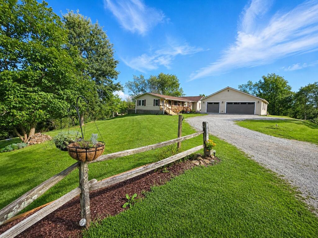 Attractive ranch-style home situated on 5+ acres in a private ridgetop setting with impressive long-range mountain views. This well-maintained home offers numerous recent updates and an open floor plan with a cozy living area and new LVP flooring. The spacious kitchen features an abundance of hickory cabinetry, granite countertops, a center island, and newer stainless appliances. The updated bathrooms add a fresh, modern touch, and a dedicated office space provides a convenient area for working from home or managing everyday tasks. Enjoy year-round comfort with a heat pump installed in 2023, an on-demand hot water heater, and a new roof installed in 2024. The home also offers a spacious primary bedroom with private bath and walk-in closet, along with plenty of comfortable living space. Outside, relax on the new back deck or covered front porch while enjoying the mountain views. A fenced backyard and additional large fenced area provide plenty of room for dogs and other pets. The 36x38 detached garage features a concrete floor and electrical service, making it ideal for vehicles, equipment, a workshop, or additional storage. The property is complemented by mature landscaping, natural rock outcroppings, apple trees, and abundant wildlife. Conveniently located within minutes of stocked trout streams, the New River, New River Trail, Jefferson National Forest, and Grayson Highlands State Park. A great opportunity to enjoy acreage, privacy, mountain views, and numerous recent improvements!