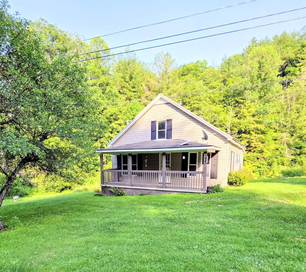 Let the creek set the pace at 6048 Clearfork Road. With approximately 850 feet of creek frontage and 1.79 acres, this Bastian property offers room to spread out, mountain views and a peaceful Southwest Virginia setting. Built in 1934, the 3-bedroom, 1-bath cottage pairs vintage character with practical updates: a metal roof installed in 2023, a wood stove added in 2024 and a recently serviced HVAC system.  Outside, usable yard space and three large fenced areas offer flexibility for pets, outdoor activities and everyday country living. Spend an afternoon beside the creek, enjoy the mountain scenery or simply settle into a quieter pace.  Whether you're looking for a year-round home or a mountain getaway, this cottage deserves a closer look. Schedule your showing and discover what life along Clearfork Road could feel like.