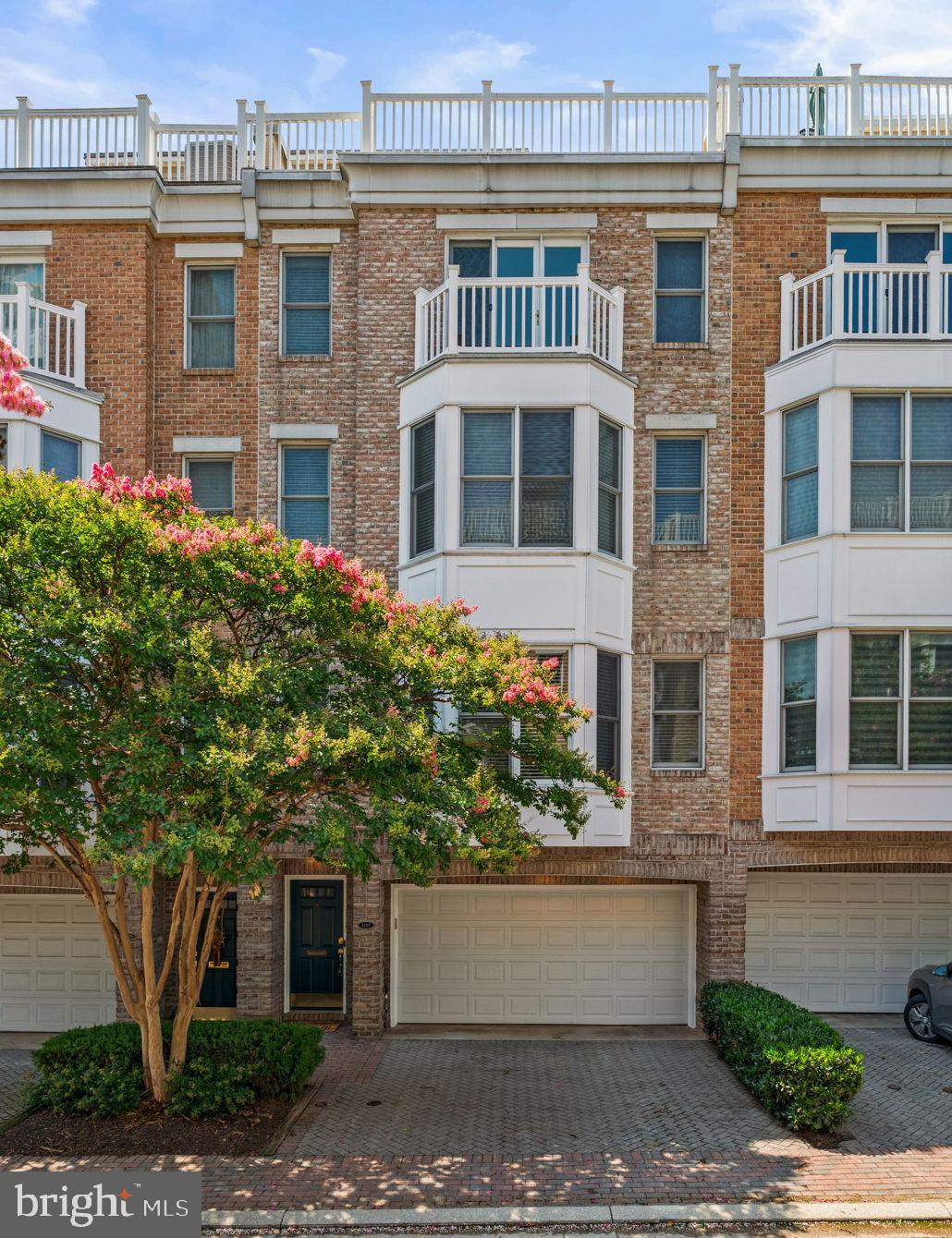 Welcome to 1207 Harbor Island Walk, an exceptional luxury townhome in the prestigious WATERFRONT COMMUNITY of HarborView. Perfectly blending elegant finishes, sophisticated design, and breathtaking views, this spacious residence offers multiple levels of thoughtfully designed living, an elevator serving all levels of the home, and spectacular outdoor spaces overlooking the Inner Harbor.    Step inside to a welcoming foyer where you'll immediately appreciate the quality craftsmanship found throughout.  Here you will find additional living space with a generously sized bedroom featuring brand-new carpet, an attached full bath, and direct access to a peaceful brick patio overlooking the tranquil community pond. This level also offers interior access to the oversized two-car garage and additional storage space.  From all levels, you are able to access the fully functional ELEVATOR, creating true ease of living in this gorgeous home!  On the next level up, the beautifully refinished hardwood floors are found throughout. Also featured are soaring ceilings, recessed lighting, and a seamless open floor plan designed for both everyday living and entertaining, alike. The gourmet kitchen is the heart of the home, showcasing granite countertops, a custom tile backsplash, a large center island, stainless appliances, a five-burner cooktop, double wall ovens, a pantry, and a spacious breakfast area. Just off the kitchen, enjoy your morning coffee or evenings unwinding on one of many private balconies. The formal dining area features custom built-in bench seating and shelving, while the spacious living room is highlighted by a cozy gas fireplace. A conveniently located powder room completes this level.  On the 2nd level up, the primary suite is created as a true owner's retreat. The spacious bedroom features hardwood flooring, recessed lighting, a ceiling fan, and elegant window treatments. A large walk-through closet leads to the luxurious ensuite bath with a dual-sink vanity, a soaking tub, and separate walk-in shower. Also on this level is a dedicated home office complete with custom built-in desk and shelving, making working from home both comfortable and convenient.    The third level up offers incredible flexibility with a spacious family room featuring custom built-ins and generous closet space, along with an additional bedroom that opens to its own private balcony. This level also includes a full bath, laundry, crown molding, and comfortable carpeting throughout.    The uppermost level is truly the crown jewel of the home. A stylish entertaining area with tile flooring, a wet bar, wine refrigerator, and skylight opens directly to the spectacular rooftop deck. Here you'll enjoy panoramic views of Baltimore's Inner Harbor, creating an unforgettable setting for entertaining guests, dining under the stars, or simply relaxing while taking in the city skyline.  BRAND NEW HVAC SYSTEMS (BOTH UNITS) BEING REPLACED 7/18/26!  Additional features include a central vacuum system, an in-home sprinkler system, and a speaker system. This luxurious home in the premier HarborView community offers far more than exceptional living space—it offers a lifestyle unlike anywhere else in Baltimore. Residents enjoy 24-hour security, a private marina, beautifully landscaped walking paths, an outdoor pool, a fully equipped fitness center, and an exclusive residents' clubhouse featuring a bar, lounge, and deli. Additional conveniences include on-site management, banking services, and impeccably maintained common areas. Spend your evenings strolling along the Baltimore Waterfront Promenade, dine at nearby waterfront restaurants, or take advantage of the community's direct access to the Inner Harbor and Federal Hill. With quick access to I-95, I-395, downtown Baltimore, Camden Yards, M&T Bank Stadium, the University of Maryland Medical Center, and countless shopping, dining, and entertainment destinations.