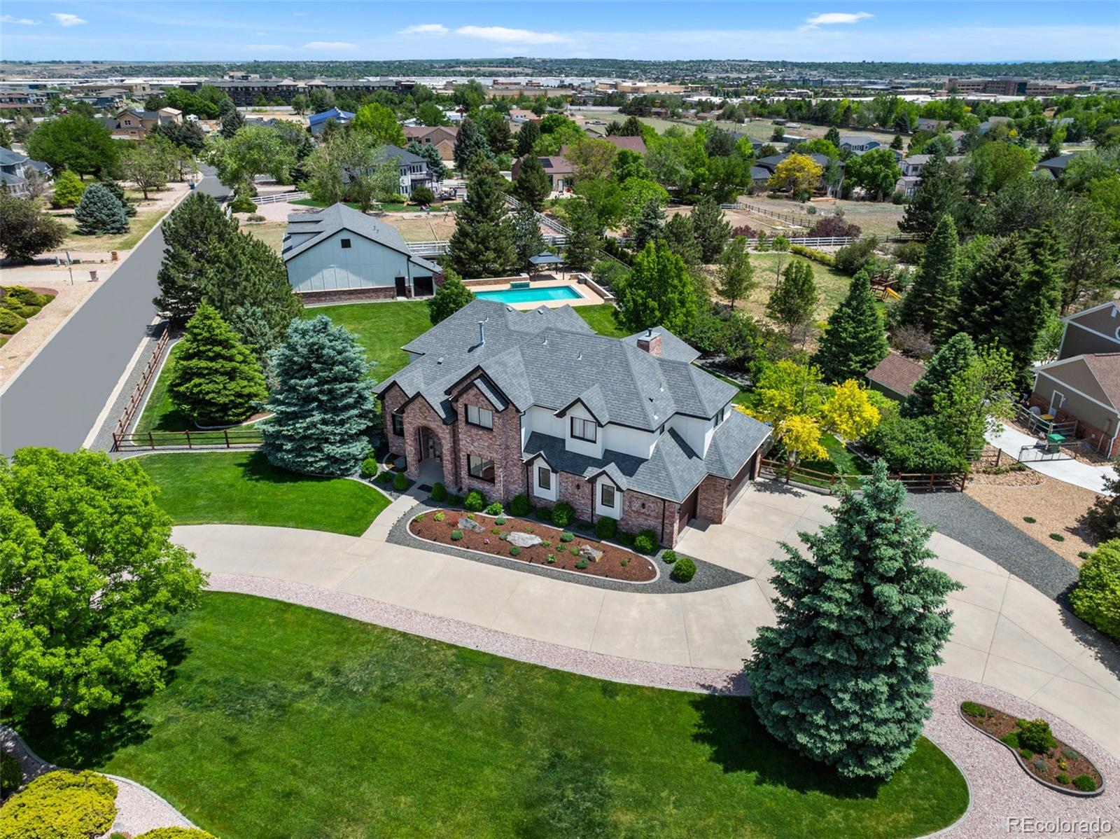 Experience true resort-style living in this impeccably maintained estate set on just over one acre in a highly desirable location near I-25, premier shopping, dining, and top-rated hospitals. Boasting more than 5,400 square feet of beautifully updated living space, this exceptional residence offers 4 spacious bedrooms, 4 bathrooms, and the opportunity to easily add 2 additional basement bedrooms and an additional bath. The luxurious primary suite serves as a private spa-inspired retreat, complete with an oversized frameless shower, soaking Jacuzzi tub, split dual vanities, and an expansive walk-in closet. Generously sized secondary bedrooms feature walk-in closets and convenient Jack-and-Jill ensuite bathrooms.Designed for both elevated everyday living and unforgettable entertaining, the home showcases soaring double-vaulted ceilings, two fireplaces, a spacious main-level study, new flooring throughout, fresh interior paint, custom Hunter Douglas blinds, Carrier Infinity HVAC system, LED undercabinet lighting, and a fully integrated Sonos sound system.At the heart of the home, the extraordinary chef’s kitchen features all-new stainless-steel appliances, granite countertops, and plumbing for a gas stove, seamlessly flowing into the incredible outdoor living space. Enjoy year-round entertaining with a covered patio featuring shades, a built-in grill, pizza oven, 6’ linear fireplace, and expansive gathering areas.The backyard is a true private retreat with a heated 18x36 in-ground saltwater pool featuring an automatic cover and waterfall, surrounded by professionally maintained landscaping and full irrigation systems in both the front and back yards.Car collectors and hobbyists will appreciate the attached oversized 3-car garage with epoxy flooring, insulation, and custom paint, along with the spectacular 2,800-square-foot heated detached garage capable of accommodating up to 10 vehicles. Perfectly blend of luxury and comfort in an extraordinary setting.