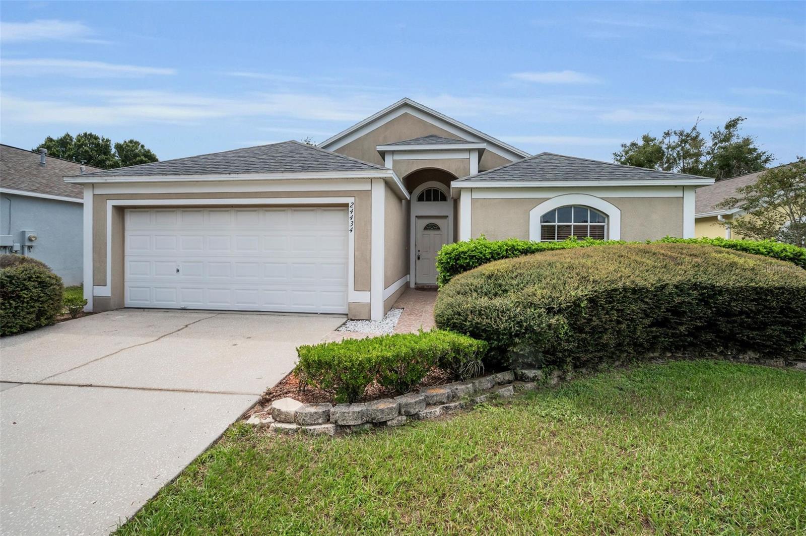 Located in the Oak Grove community of Lutz this charming 3/2 is located on a quiet cul-de-sac in a desirable Lutz neighborhood. Featuring an open floor plan highlighted with natural light and vaulted ceilings offers a warm and inviting atmosphere throughout.  The kitchen with a large pantry and breakfast dining flows seamlessly into the living area, making it ideal for both everyday living and hosting guests. Additional highlights include a split-bedroom layout, new roof in 2020, 2 car garage, ample natural light, and a generous primary suite with an en-suite bathroom and large walk in closet. Enjoy privacy and outdoor living with a screened lanai and fully fenced backyard, perfect for relaxing or entertaining and plenty of room for kids or pets to play! Conveniently located near shopping, dining, and major highways, this home offers both comfort and accessibility. Don’t miss the opportunity to make this charming property your own!