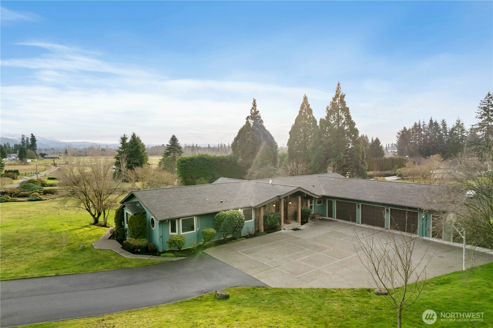 Exceptional single-story home with 2,750 sq ft on a 84,942 sq ft lot. Breathtaking, unobstructed views of Mt Rainier and the Cascade foothills from the main living areas. This 4 bedroom, 3 bath home features a spacious primary suite w/ private bath & walk-in closet and a versatile 4th bedroom  currently used as an office/den. The kitchen showcases quartz counters, SS appliances, and flows seamlessly into bright living spaces highlighted with hardwood & durable LPV flooring. Huge 1,510 sf ft garage w/ storage cabinetry and dedicated shop space.  Enjoy the expansive level grounds w/ garden area, outbuildings, endless outdoor recreation, and room to grow. This property offers space, views, and versatility rarely found. Close to everything.