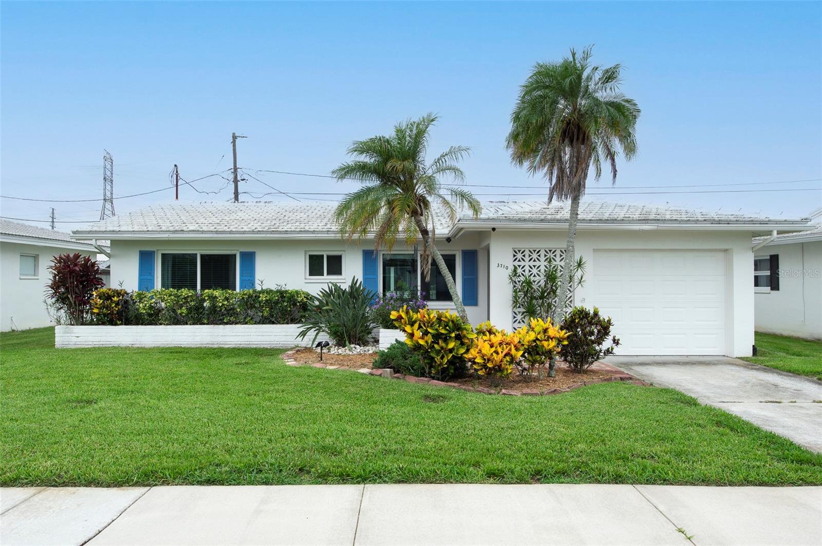 Welcome to your perfect Florida retreat! Located in the highly sought-after, 55+ community of the Mainlands of Tamarac (Unit 3), this move-in-ready Drayton Model single-family home features 2 bedrooms, 2 bathrooms, a 1-car garage, and 1,276 square feet of comfortable living space. Inside, you will find a beautifully updated kitchen with granite countertops, soft-close cabinets, and appliances, plus a breakfast bar that opens into a bright Florida Room flooded with natural light. The home offers excellent peace of mind with some windows replaced, a newer flat roof (2022), a tile roof (2004), and a RHEEM HVAC system (2015).Living here means embracing a fun, maintenance-free lifestyle. The community association handles your lawn care and roof maintenance, giving you more time to enjoy the golf cart-friendly neighborhood, public Par 67 golf course, community pools, and social clubs. Unit 3 is wonderfully pet-friendly with no weight limits. Nestled in the heart of Pinellas County, you will be just minutes from pristine Gulf Coast beaches, fantastic dining, and major highways for easy access to Tampa Bay sports and entertainment. Don't miss out on this carefree coastal paradise!