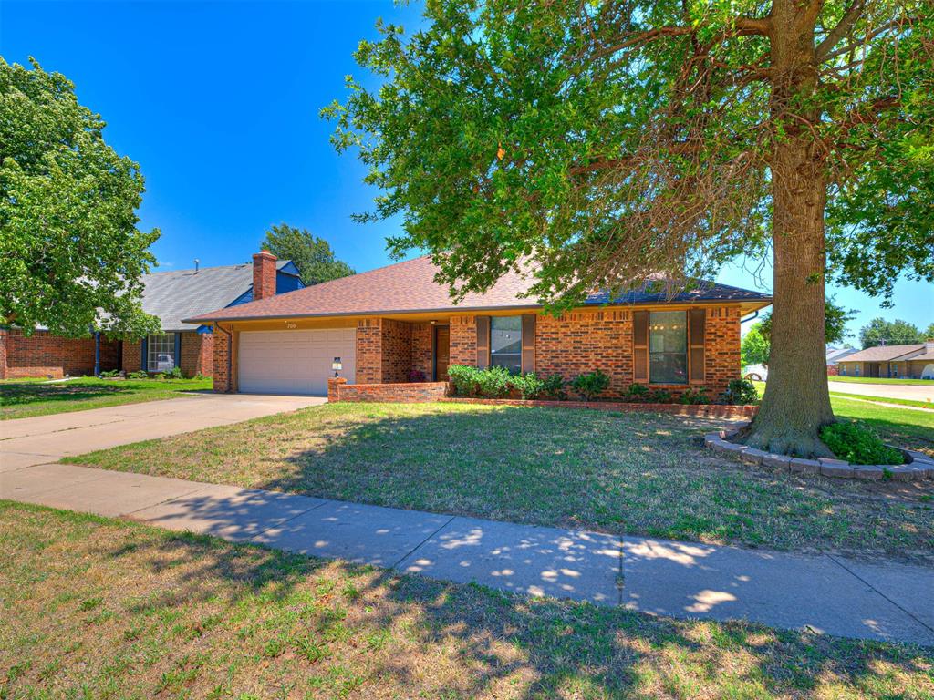 Welcome home to this move-in ready gem in the desirable Greenbriar addition and highly sought-after Moore School District. Situated on a spacious corner lot shaded by a magnificent mature oak tree, this well-maintained home offers comfort, character, and exceptional versatility. Inside, you'll find 1,585 square feet of inviting living space featuring two generously sized bedrooms, beautiful wood cabinetry, neutral finishes, newer wood-look flooring, and an open-concept layout designed for everyday living and entertaining. A unique double-sided gas fireplace creates a warm focal point, connecting the living and dining areas with charm and ambiance. The spacious 20' x 10' sunroom provides additional year-round living space and serves as a seamless transition to the outdoors. Step outside to the expansive 20' x 14' covered patio, perfect for relaxing, grilling, or gathering with family and friends. A standout feature is the impressive 23' x 10' workshop/storage building complete with electricity, offering endless possibilities for hobbies, projects, storage, or a home workshop. The oversized backyard provides ample room for gardening, pets, play, or future outdoor enhancements and includes the added peace of mind of an in-ground storm shelter. Additional updates include a roof replacement in 2021 and other recent improvements. Residents will also enjoy convenient access to the nearby neighborhood park featuring a pavilion, playground, tennis courts, and basketball courts. This home combines space, functionality, and opportunity in a fantastic location. Move in today and add your personal touches to make it your own.