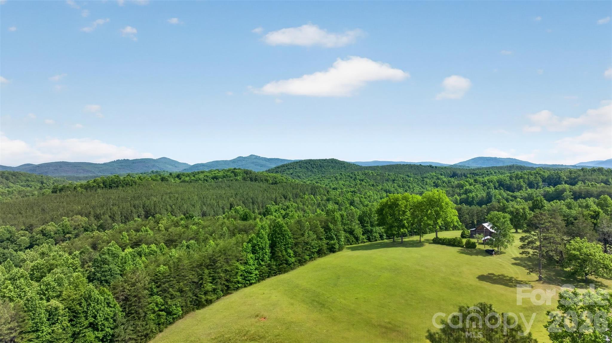 247.46 Acres | Union Mills, NC | Historic Frontier Cabin | Mountains, Creeks & PastureThere are properties you buy. And then there are properties that find you.This is the latter.Tucked into the mountains of Rutherford County, 247.46 acres of pure, untouched North Carolina waits for the person who's been quietly dreaming of something more — more space, more silence, more life. Not a subdivision lot. Not a neighborhood. Not an HOA newsletter. A place where the only thing on the horizon is mountain views, and the only sound at dusk is water moving over rock.The land has it all: sweeping mountain views that stop you in your tracks, open pasture, hardwood forest, and creek frontage that would make a grown man stop and just breathe. Whether you're a hunter looking for your own private ground, a horseman wanting room to roam, or simply someone who has had enough of the noise — this land meets you where you are.At the heart of it stands a cabin that defies modern time. Built in the 1700s or early 1800s, this cabin features a main room anchored by a beautiful fireplace with a kitchen and full bath. It is a living relic of American frontier life in these mountains. Look closely at the walls and you'll find the original rifle ports — narrow openings hand-cut by the settlers who built this place and defended it. This isn't a cabin that was decorated to feel historic. It is history. It has earned its age. Every notch and worn plank tells a story most people will never get to touch.In a world that moves faster every year — where the headlines are relentless, the cities are louder, and privacy feels like a luxury — land like this has become something else entirely: a refuge. A reset. A place to raise your kids the way you were meant to. To hunt your own ground. To sit on a porch in front of a cabin that was standing before this country was what it is today, and feel something settle inside your chest.The seller will not subdivide. This land sells whole, 247.46 acres, one piece, one legacy, one opportunity.Some things are worth protecting. This is one of them.