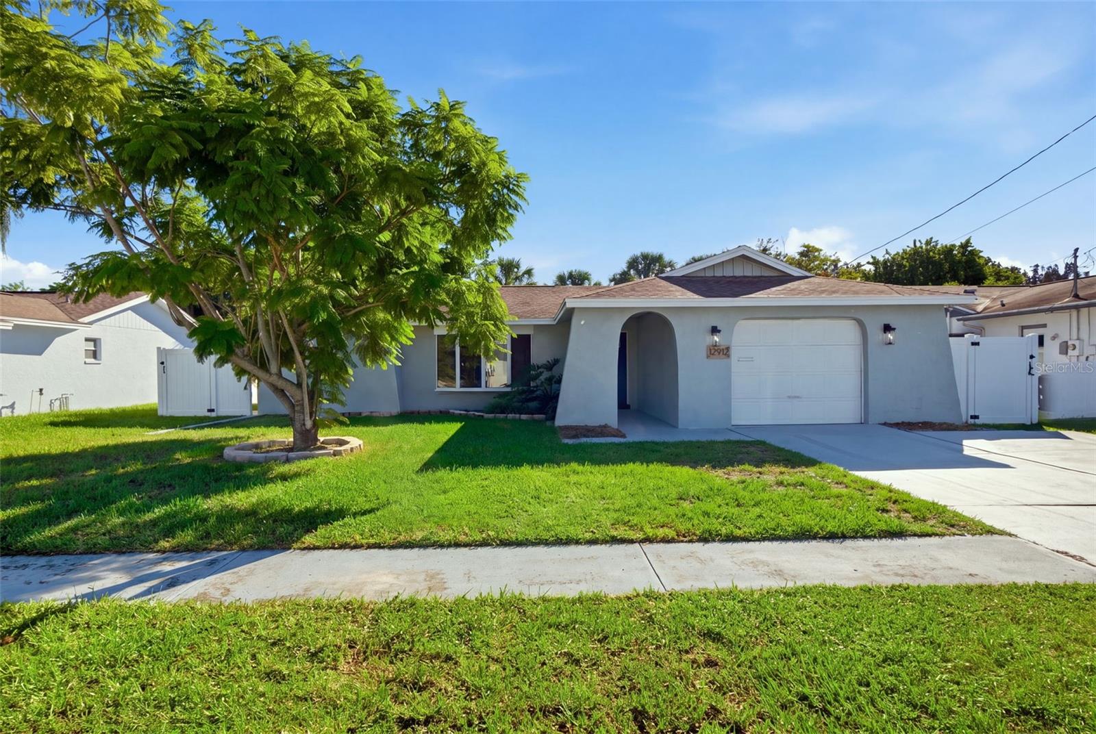 Welcome to your slice of Florida paradise in the desirable Leisure Beach community! COMPLETELY REMODELED and MOVE-IN READY, this beautifully updated 3-bedroom, 2-bathroom, 1-car garage POOL HOME offers the perfect combination of modern upgrades, coastal charm, and the Florida lifestyle. Featuring an open-concept floor plan, abundant natural light, and thoughtfully selected finishes throughout, this home has been transformed with comfort, style, and entertaining in mind.Step inside to discover an interior featuring NEW luxury vinyl plank flooring throughout, a spacious living area, and a charming wood-burning fireplace that adds warmth and character. The remodeled kitchen serves as the heart of the home, showcasing NEW cabinetry, quartz countertops, stainless steel appliances, and an open layout that flows into the living room. Whether you're entertaining guests or enjoying a quiet evening at home, the thoughtfully designed floor plan offers both functionality and style.Beyond the beautiful finishes, this home boasts major improvements, including a NEW 2026 HVAC system, NEW 2026 water heater, and updated electrical and plumbing in 2026, along with a newer roof. These upgrades provide added comfort and peace of mind, allowing you to spend more time enjoying everything this home and community have to offer.Designed to embrace Florida's indoor-outdoor lifestyle, multiple French doors fill the home with natural light and provide access to your private backyard oasis. Step outside to discover a screened-in swimming pool, expansive covered lanai, and spacious vinyl-fenced backyard, offering the perfect setting for entertaining, weekend barbecues, relaxing poolside, or enjoying the beautiful Florida weather. With generous outdoor living space and a private setting, this backyard is truly an extension of the home.Located in the established Leisure Beach community of Hudson, this property offers the freedom of NO MANDATORY HOA and NO CDD FEES! Residents also have the option to participate in the Leisure Beach Civic Association for an annual fee of just $50, providing opportunities to connect with neighbors and enjoy community activities throughout the year.Leisure Beach is known for its welcoming neighborhood atmosphere and proximity to the Gulf Coast's recreational opportunities. Community traditions include the annual Christmas boat parade, festive golf cart parades, neighborhood flotillas, and monthly "Coffee in the Cul-De-Sac" gatherings that bring residents together. Outdoor enthusiasts will appreciate nearby Werner-Boyce Salt Springs State Park, where scenic kayaking trails, natural waterways, and abundant wildlife offer opportunities to explore Florida's natural beauty.When it's time to venture out, you're just minutes from local favorites like Skinny's Bar and Grill and Inn on the Gulf, along with waterfront dining, boating opportunities, and the coastal attractions that make Hudson such a desirable place to call home.COMPLETELY REMODELED. PRIVATE SCREENED POOL. MAJOR 2026 UPGRADES. NO MANDATORY HOA. NO CDD. Whether you're searching for a primary residence, seasonal getaway, or your own private Florida retreat, this Leisure Beach home delivers the ideal blend of modern comfort, outdoor living, and coastal convenience. Enjoy living near the water without the waterfront price tag. Your Florida lifestyle starts here!