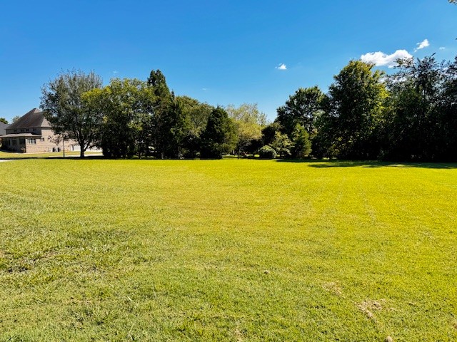 Discover the perfect setting for your dream home on this beautiful vacant lot located in one of the area's most prestigious neighborhoods. Just mins. from the sparkling waters of Tims Ford Lake, this property offers convenience and space. With a spacious setting and prime location, you'll enjoy the peace of a refined community while staying close to marinas, outdoor recreation, dining, and shopping. This lot provides the ideal foundation for a lifestyle of comfort and elegance.  2300 sq ft minimum.