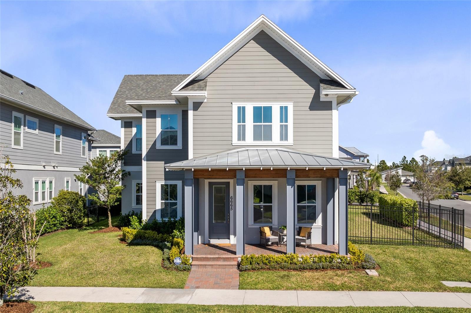 Experience modern elegance and unmatched flexibility in the heart of Laureate Park, Lake Nona. This standout property includes a private, detached garage apartment—complete with its own entrance, full kitchen, bathroom, and living space. Whether used as a rental, guest suite, or multigenerational setup, this bonus space adds major value and versatility.

Situated on one of the largest corner lots in the community, the main home offers nearly 3,500 sq ft of designer living. A charming front porch with modern metal columns and wood beams welcomes you inside, where custom finishes shine—from the herringbone-tiled office to the open-concept kitchen, dining, and living areas. The gourmet kitchen features sleek cabinetry, premium appliances, and a quartz island built for gathering.

The first-floor primary suite offers backyard views, a spa-style ensuite with an oversized shower, and a custom walk-in closet. Upstairs, three additional bedrooms, two full baths, and a private studio with a kitchenette and full bath offer even more flexible living options.

Additional perks include an extended driveway for five vehicles, a custom drop zone, and a three-car garage.

Laureate Park isn’t just a neighborhood—it’s a vibrant lifestyle. Enjoy the Aquatic Center, resort-style pools, LP Fit gym, and 44+ miles of trails. Minutes from Medical City, dining, shopping, major highways, MCO Airport, and the USTA National Campus. This home delivers luxury, location, and the rare bonus of income-generating potential. Schedule your private tour today!