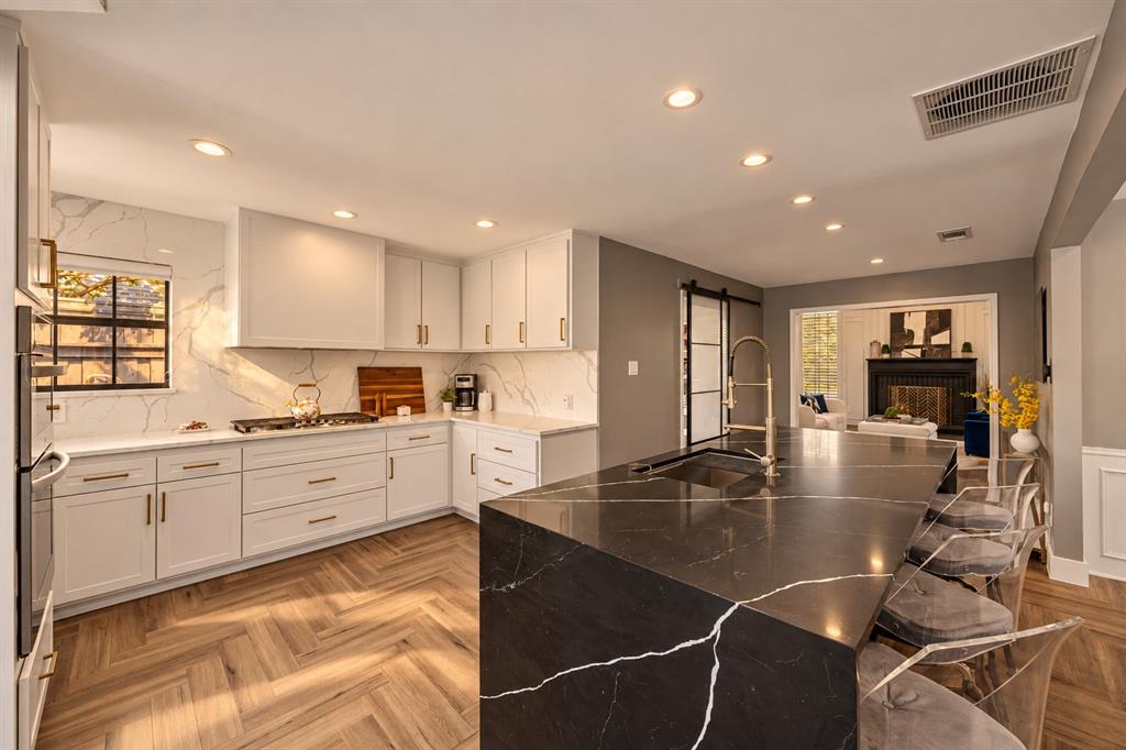 Looking for the perfect location, great floor plan, and awesome financial incentives? Steeplechase is one of the most desirable neighborhoods in West Plano with homes selling well over a million dollars. This floor plan is unique and functional - no cookie cutters here! Plus, now through November 3rd, the seller is willing to offer $20,000 towards your choice of rate buy-down, repairs, or seller concessions towards cosmetic items. If you love to entertain, this home gives you the space to do it beautifully. Soaring vaulted ceilings, walls of windows, designer lighting, and herringbone flooring create a warm, inviting setting, with generous living and dining areas that make gathering easy. The kitchen is a standout, with custom cabinetry, white  and dark quartz island with a gallery sink that is perfect for hosting. A gas cooktop, premium stainless appliances, built in oven and microwave, hidden appliance station, oversized pantry, and tucked away refrigerator keep everything looking clean while working hard behind the scenes. Two bedrooms downstairs and two upstairs offer flexibility for guests, family, or multigenerational living, and every bedroom connects to a bathroom. The bathrooms give you the opportunity to choose your own cosmetic updates and make the home feel like yours. Upstairs, an extra large walk in closet offers potential to finish out as an office or create a space that fits your needs, subject to necessary approvals. Outside is where you will want to spend your evenings. Enjoy the sparkling pool, expansive deck, and spa with a gas heater ready for cold winter nights. Mature trees frame the beautiful lot, and yes, the magnolia is coming back too! Turf in the backyard keeps maintenance easy so you can spend more time enjoying it. Beautifully updated where it counts, with room to add your own style, all conveniently located near parks, shopping, and schools.